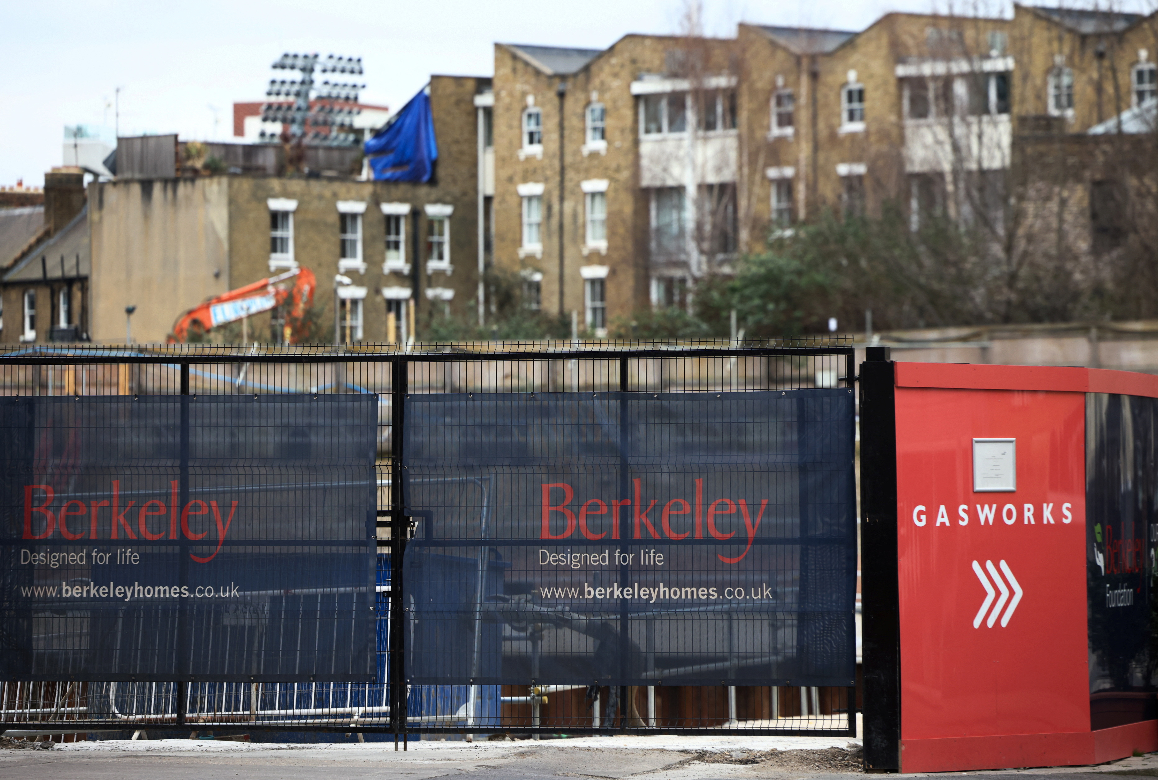 Hoardings display a logo of Berkeley Group outside a development in London