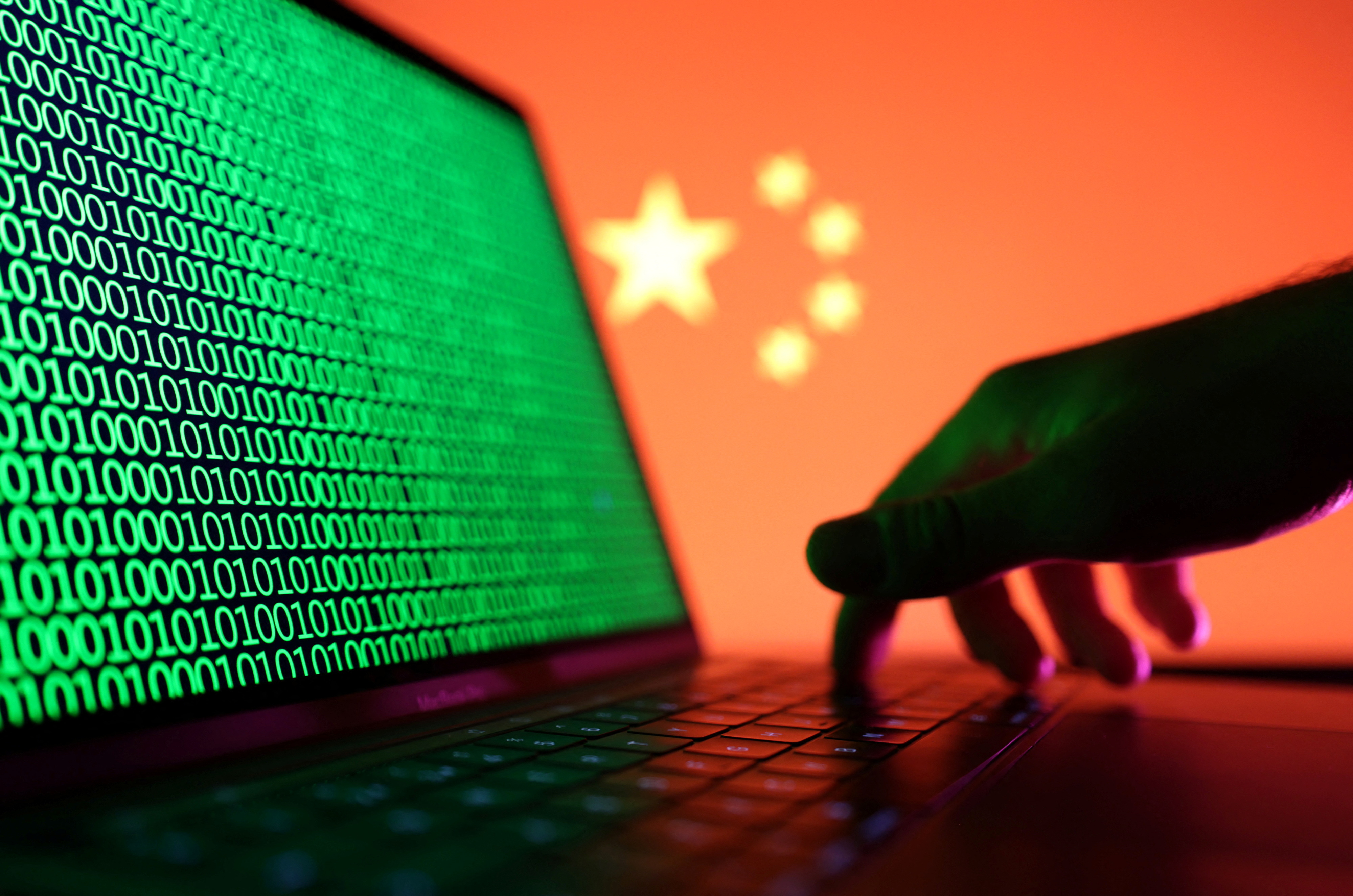 Illustration shows a laptop with binary codes displayed in front of the Chinese flag