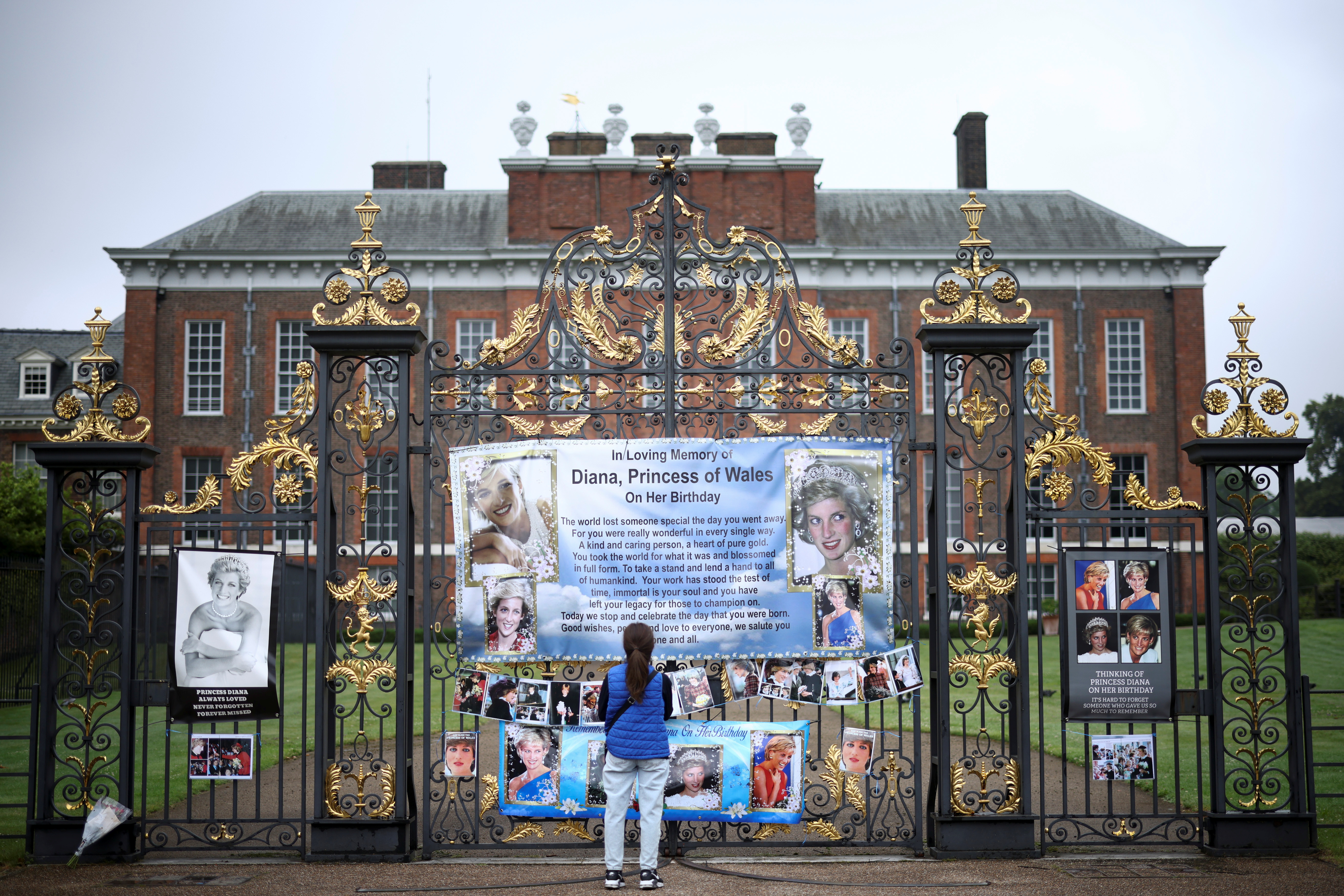 A person looks at tributes for Britain's Princess Diana, outside Kensington Palace in London