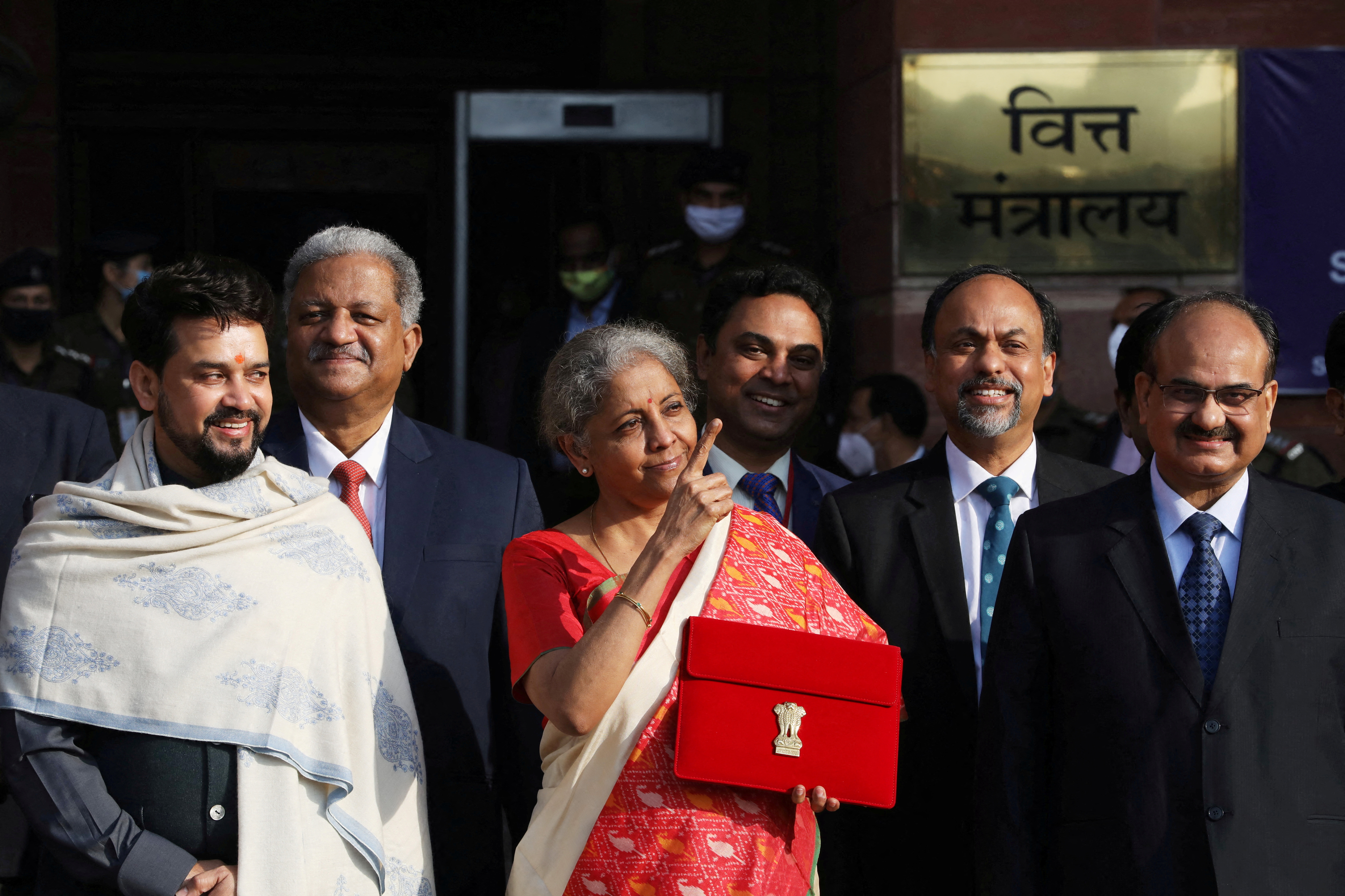 India's Finance Minister Nirmala Sitharaman stands next to Minister of State for Finance and Corporate Affairs Anurag Thakur as she leaves her office to present the federal budget in the parliament in New Delhi