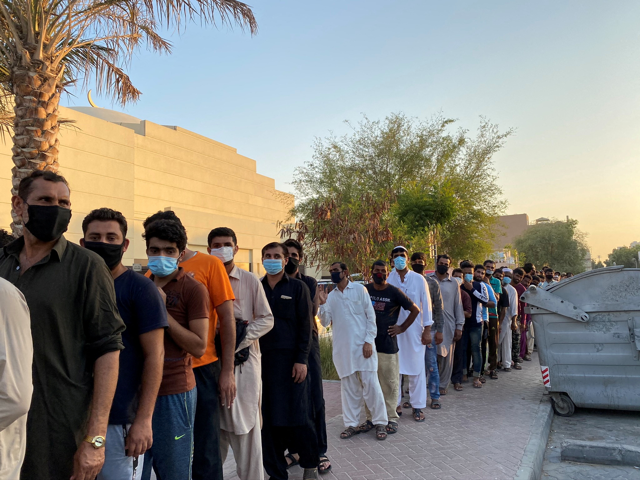 Unemployed men queue for food handouts from concerned local residents after they lost incomes due to the coronavirus disease (COVID-19) pandemic in Dubai