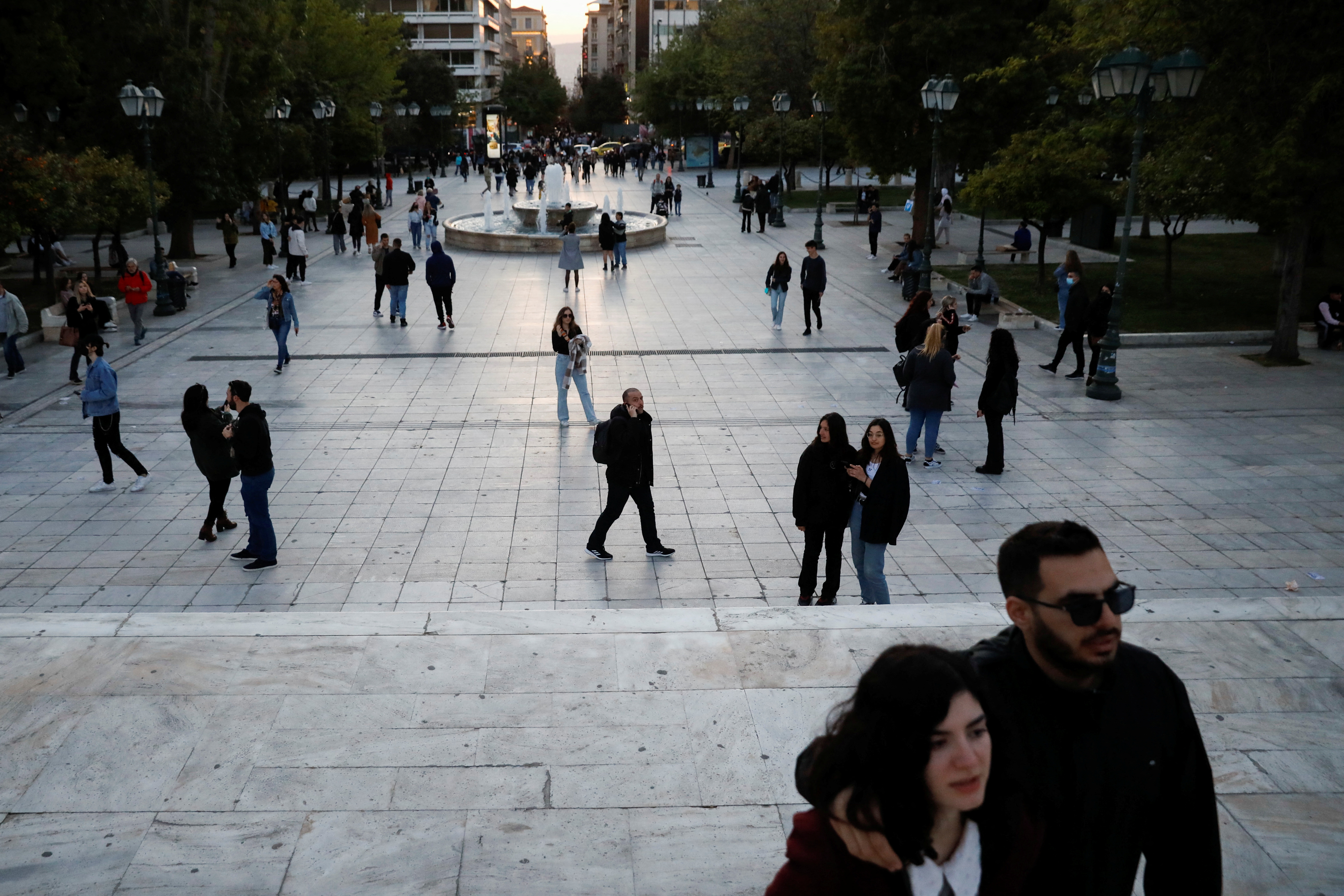 People walk in Syntagma square, in Athens