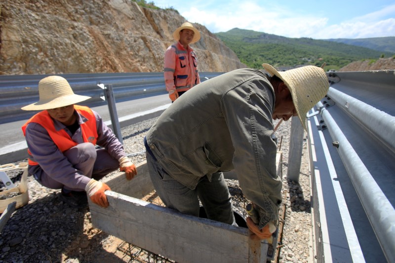 Workers fit a manhole on the Bar-Boljare section of a new highway in Montenegro financed with a large Chinese loan, May 27, 2021. REUTERS/Stevo Vasiljevic/File Photo