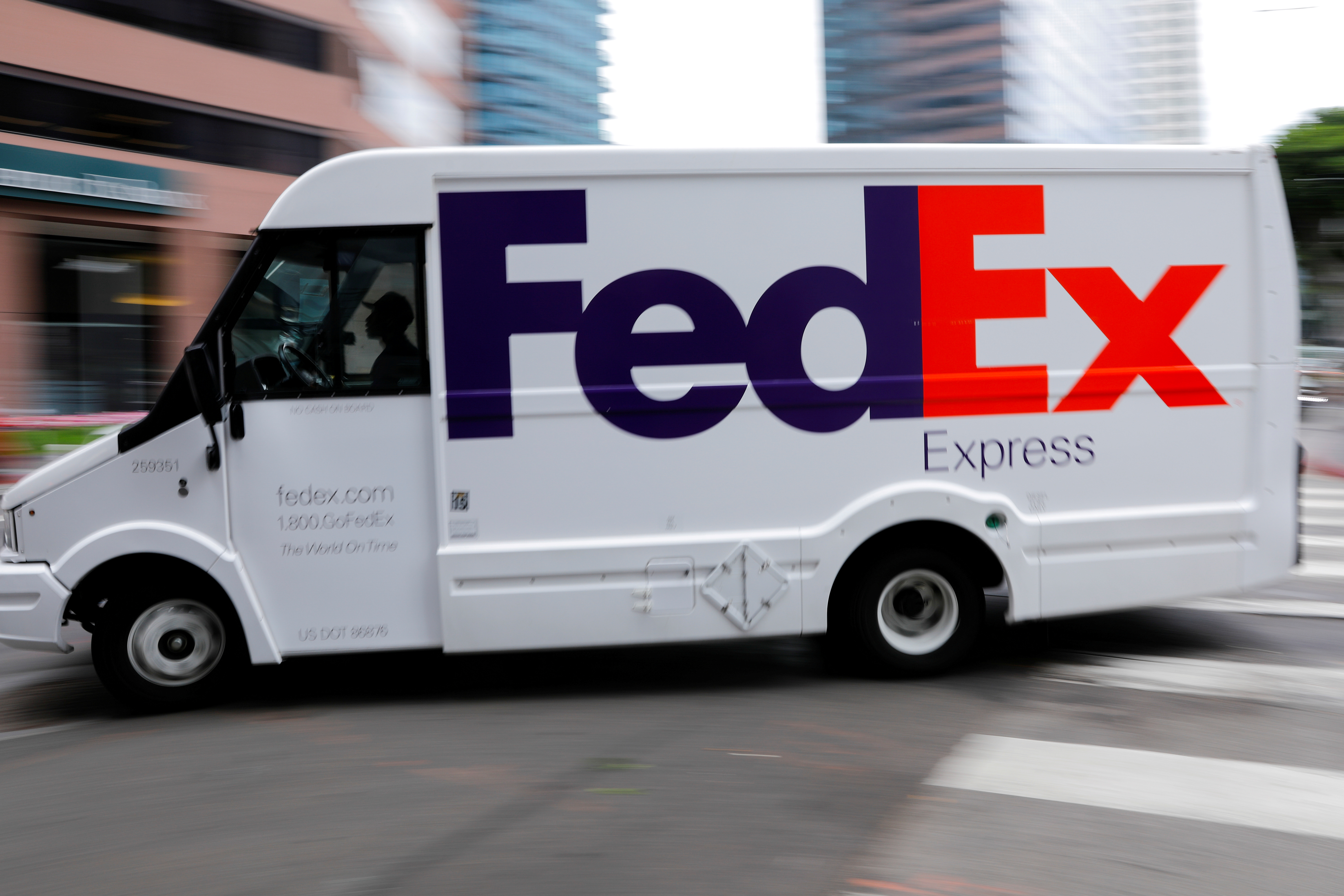 A FedEx truck is driven through downtown in Los Angeles