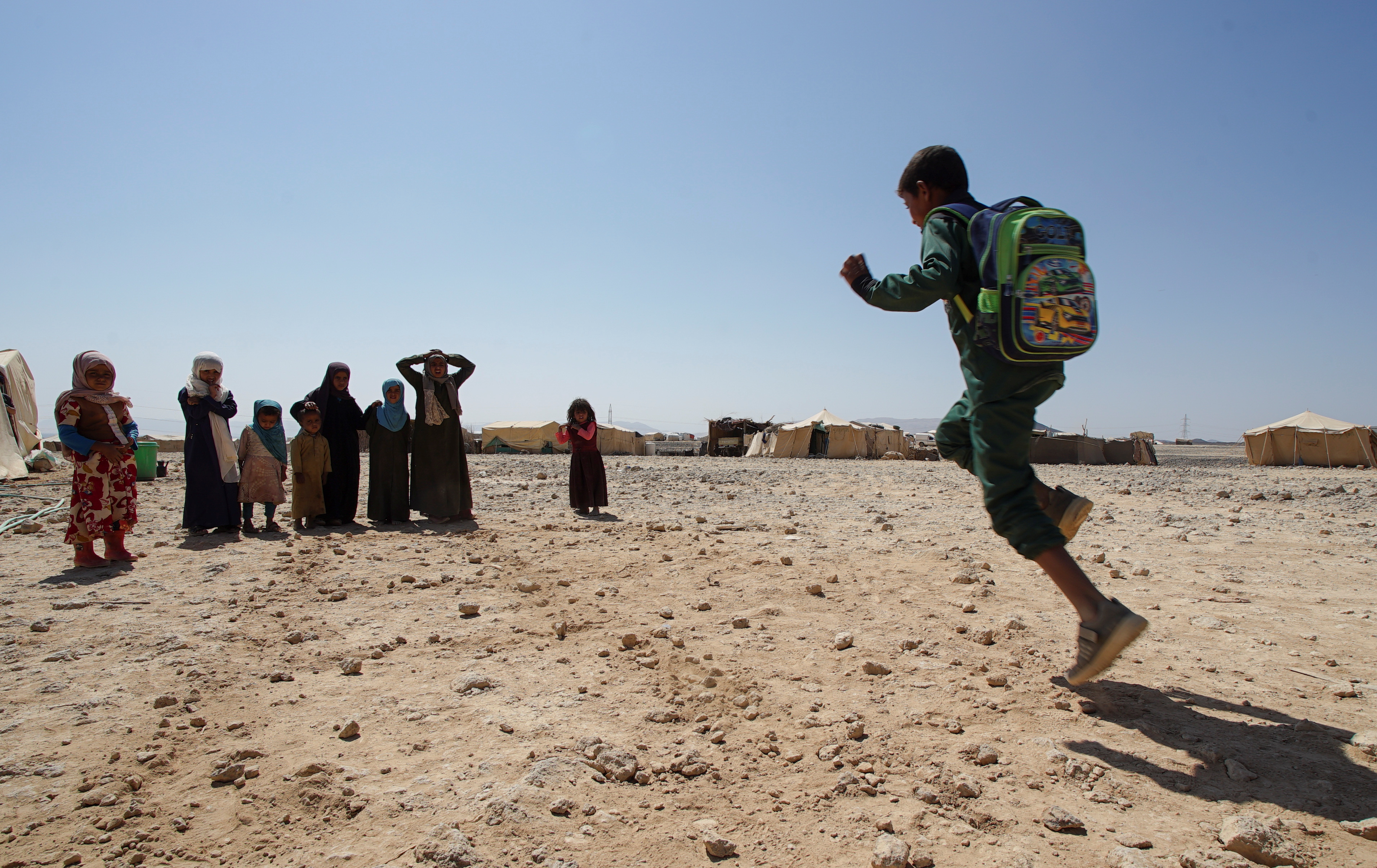 Children play at a camp for IDPs in Marib