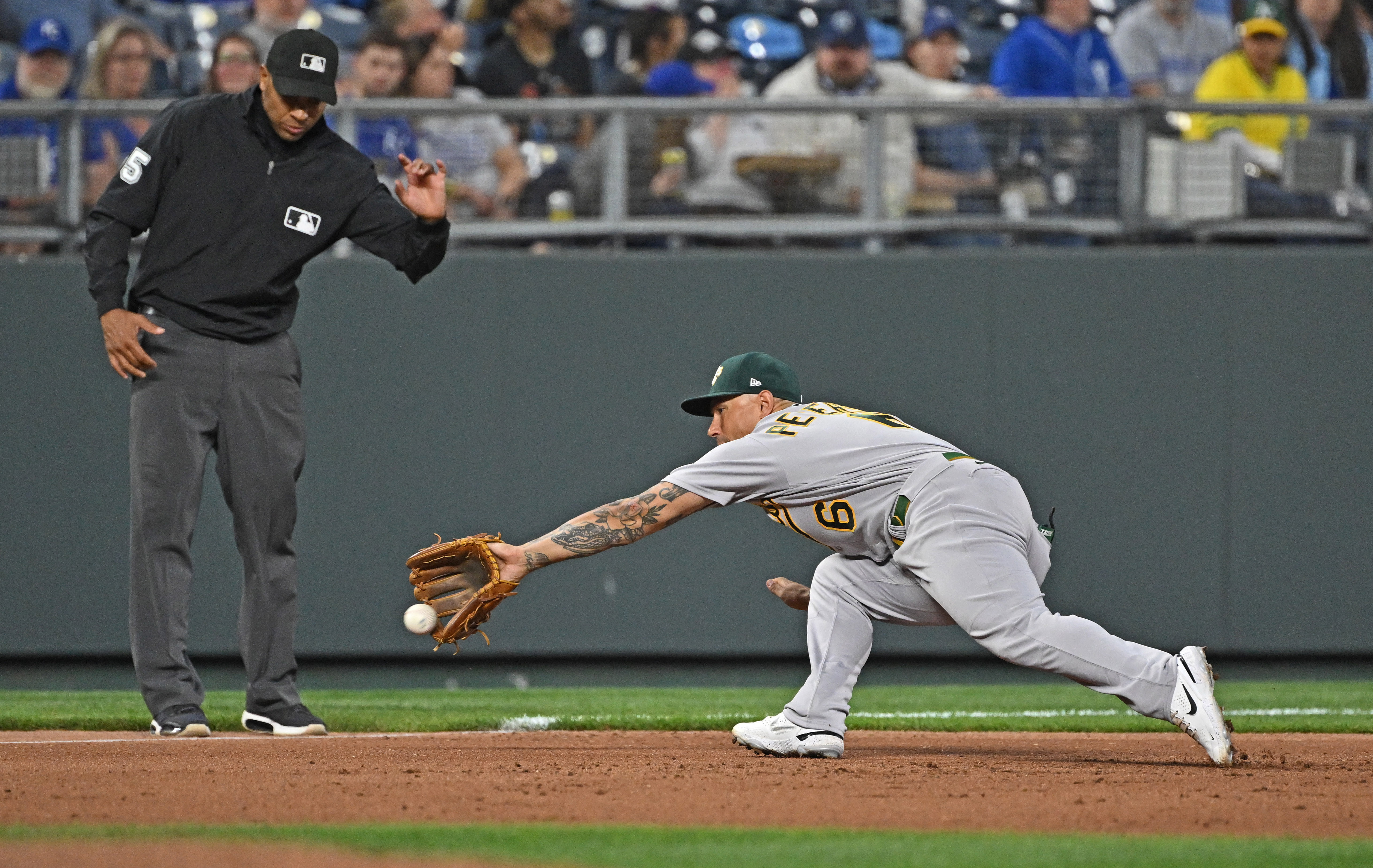 A's score big, hold off Royals' comeback bid