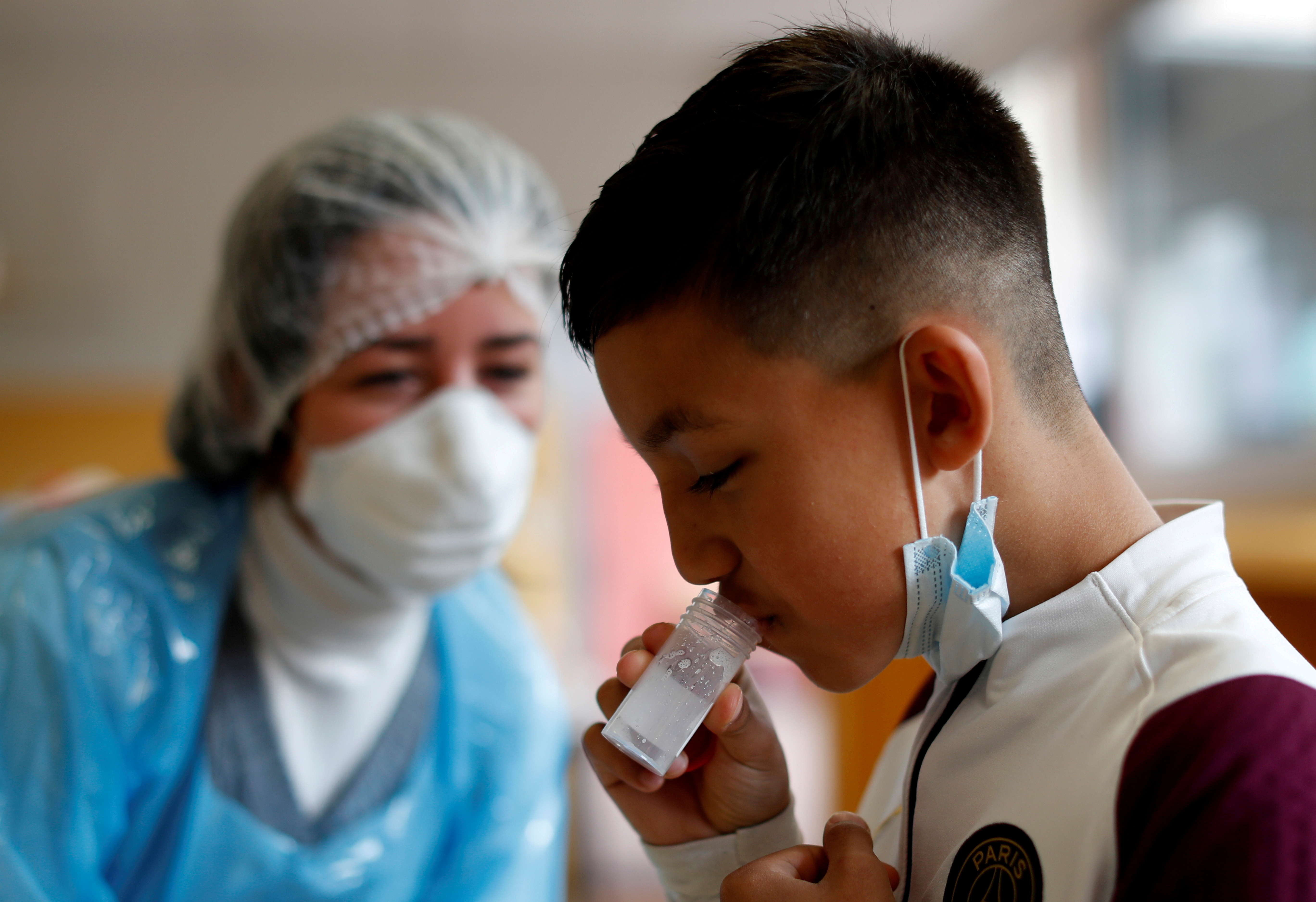 A schoolboy gives a sample during a COVID-19 saliva test at Lepeltier primary school in La Trinite, near Nice, amid the coronavirus disease (COVID-19) outbreak in France, April 26, 2021.    REUTERS/Eric Gaillard/File Photo