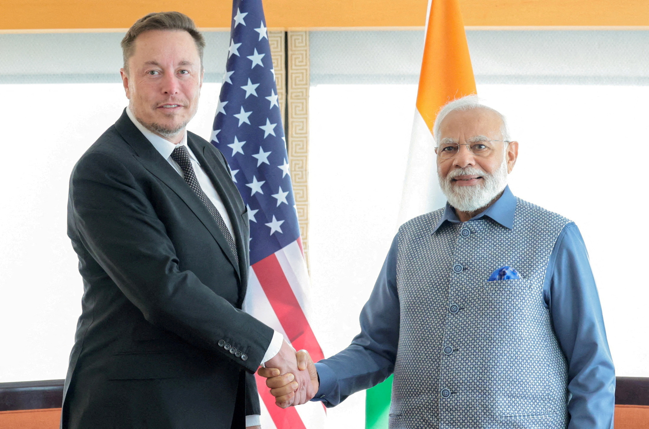 India's Prime Minister Narendra Modi shakes hands with Tesla CEO Elon Musk in New York