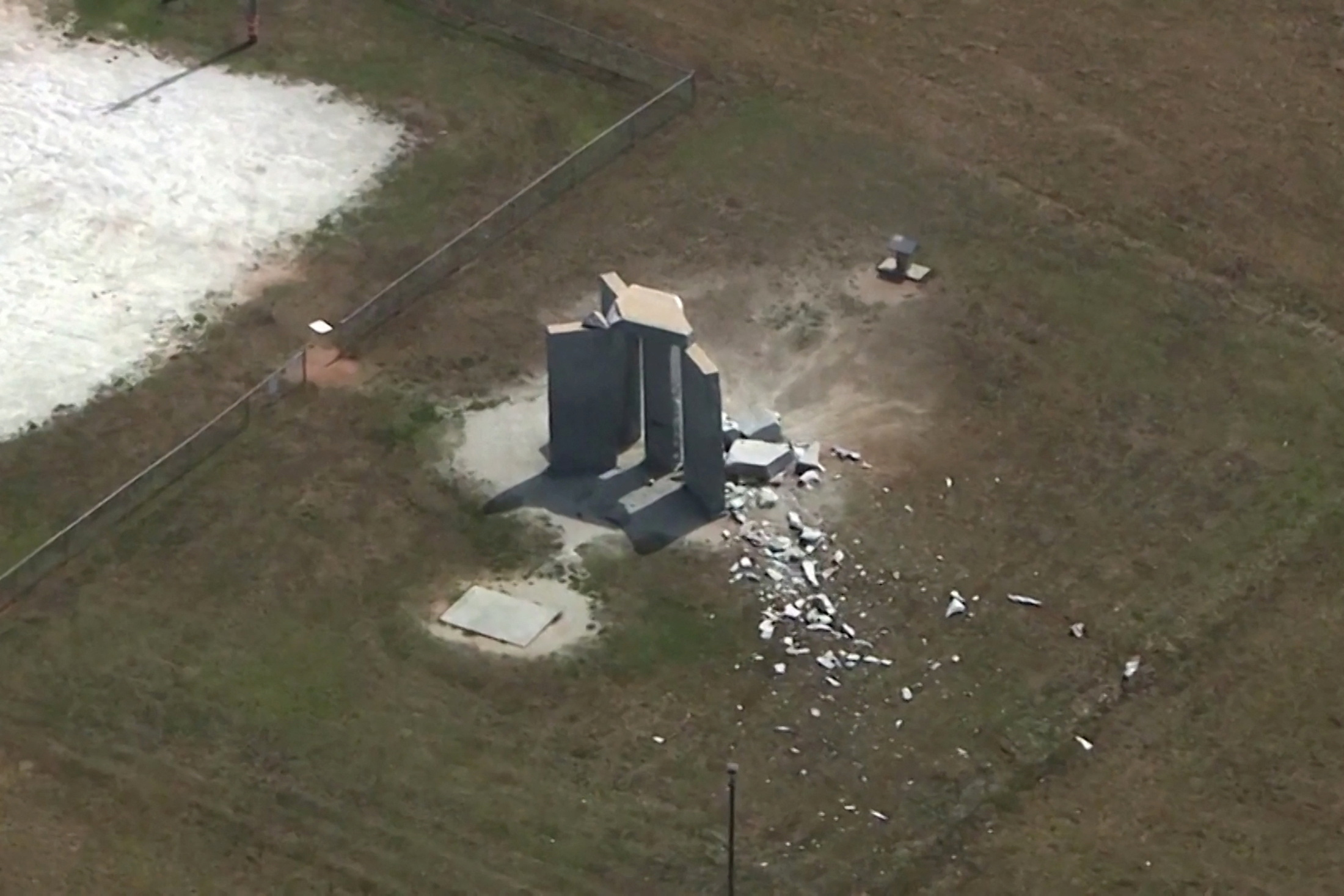 Rubble is cast around the Georgia Guidestones after an explosion in Elberton