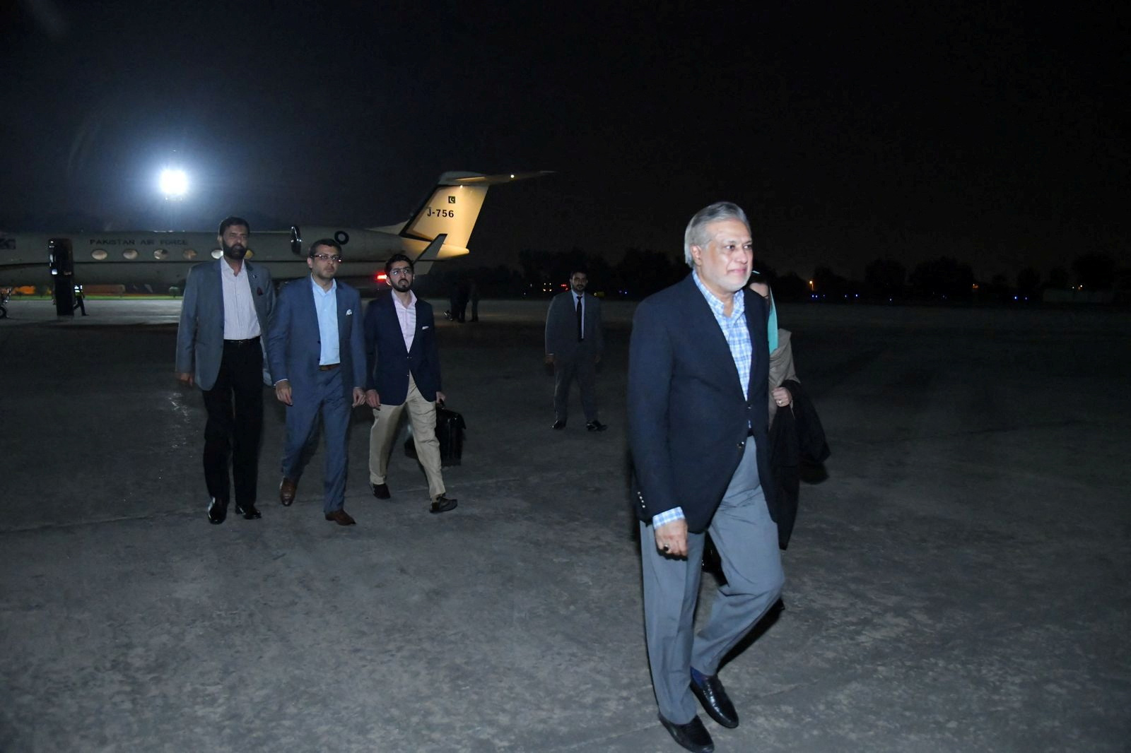 Pakistan's likely new Finance Minister Ishaq Dar walks upon his arrival at the Nur Khan military airbase in Chaklala, Rawalpindi