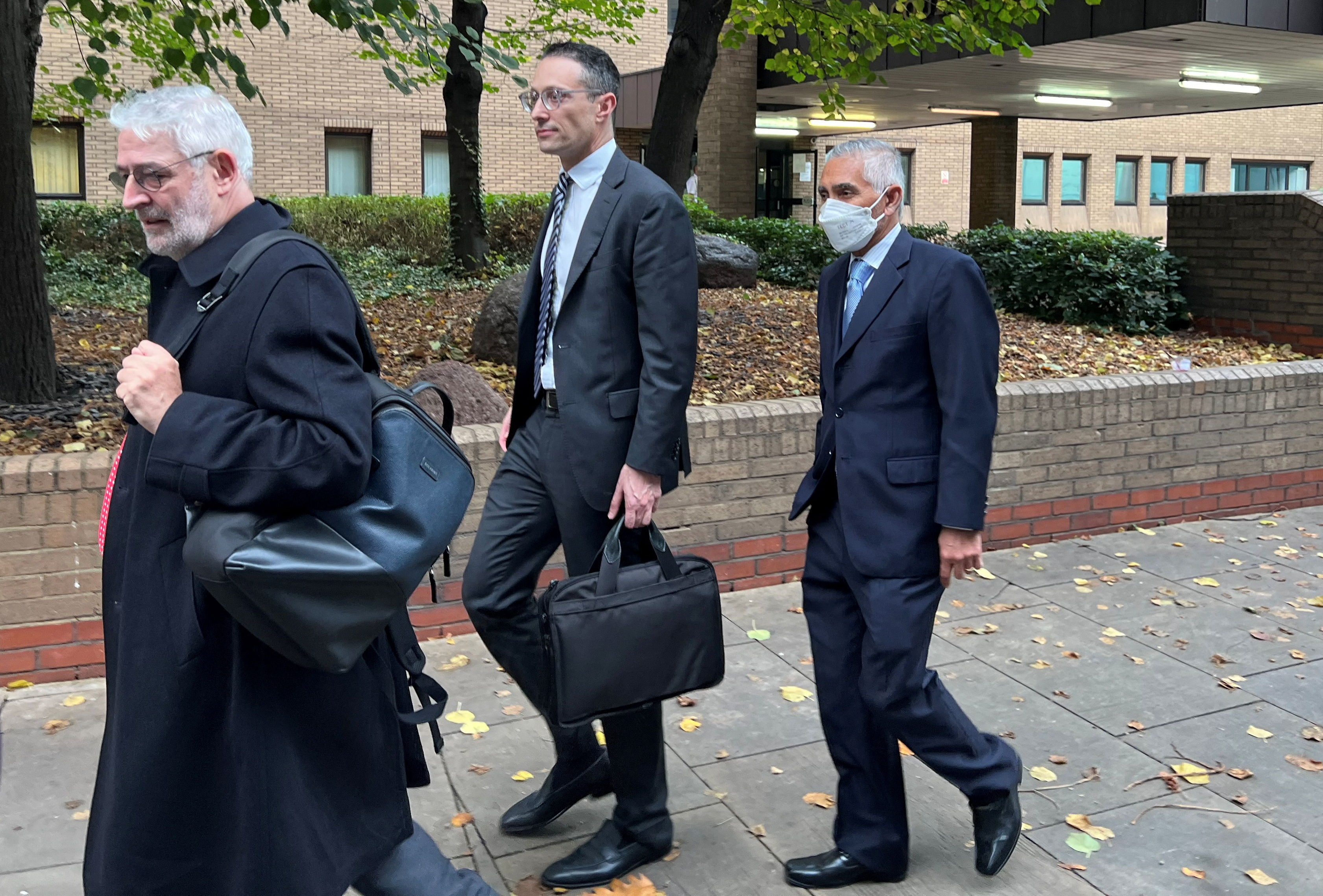 Glencore's chairman Kalidas Madhavpeddi and Glencore's general counsel Shaun Teichner leave Southwark Crown Court in London