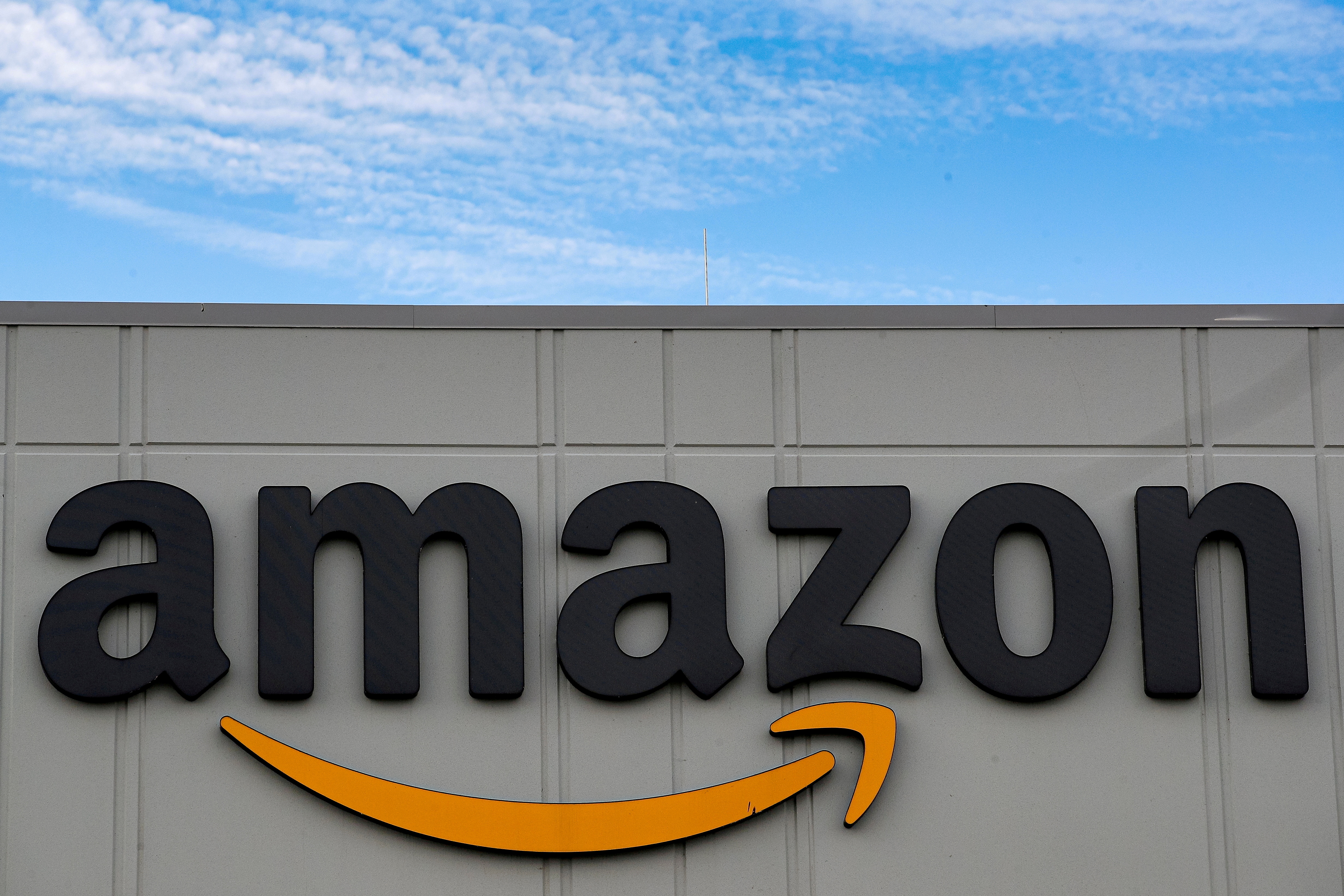 The Amazon logo is seen outside its JFK8 distribution center in Staten Island, New York, U.S. November 25, 2020.  REUTERS/Brendan McDermid