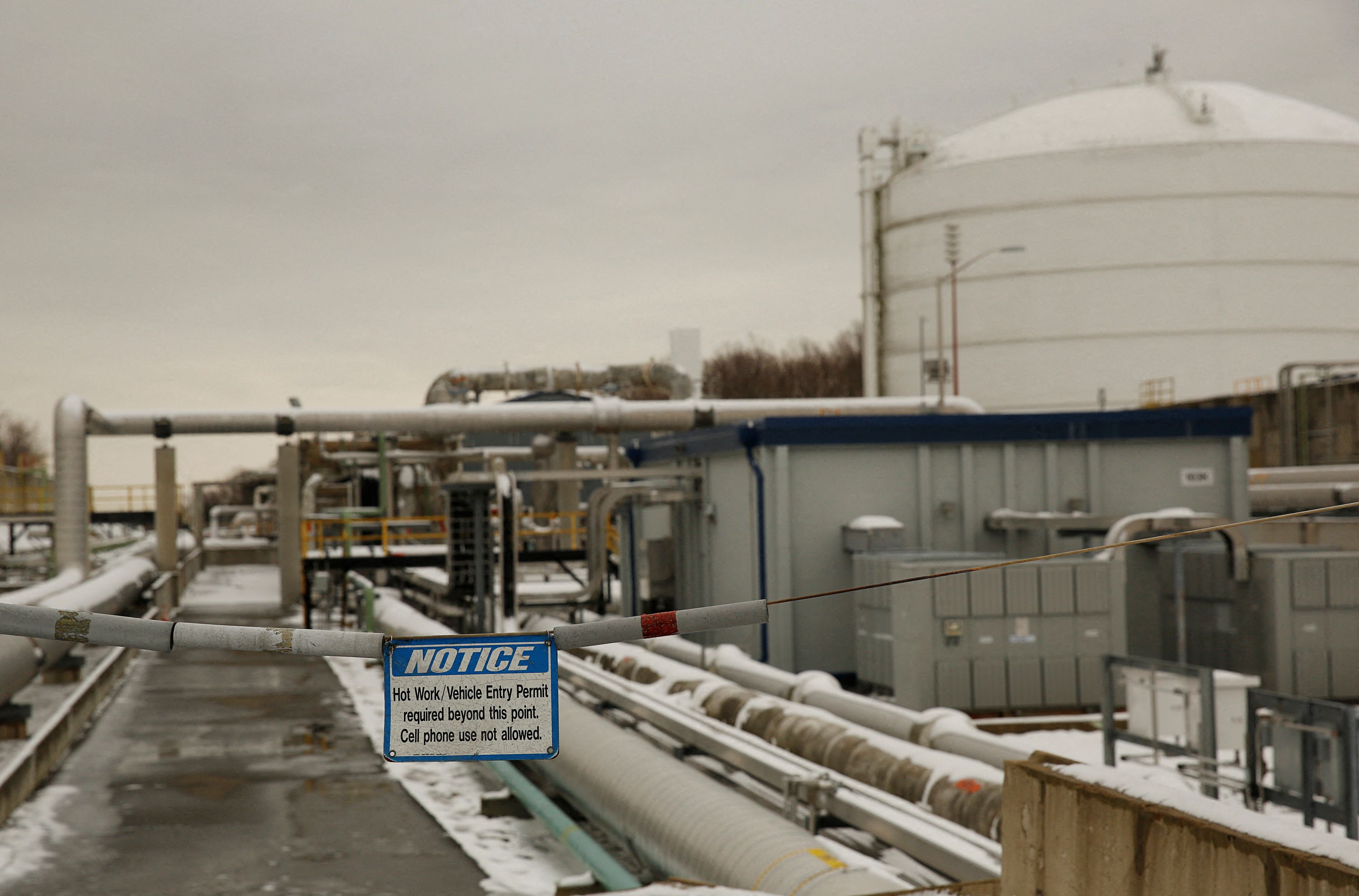 Warning sign is seen with transfer lines at Dominion Cove Point Liquefied Natural Gas terminal in Maryland