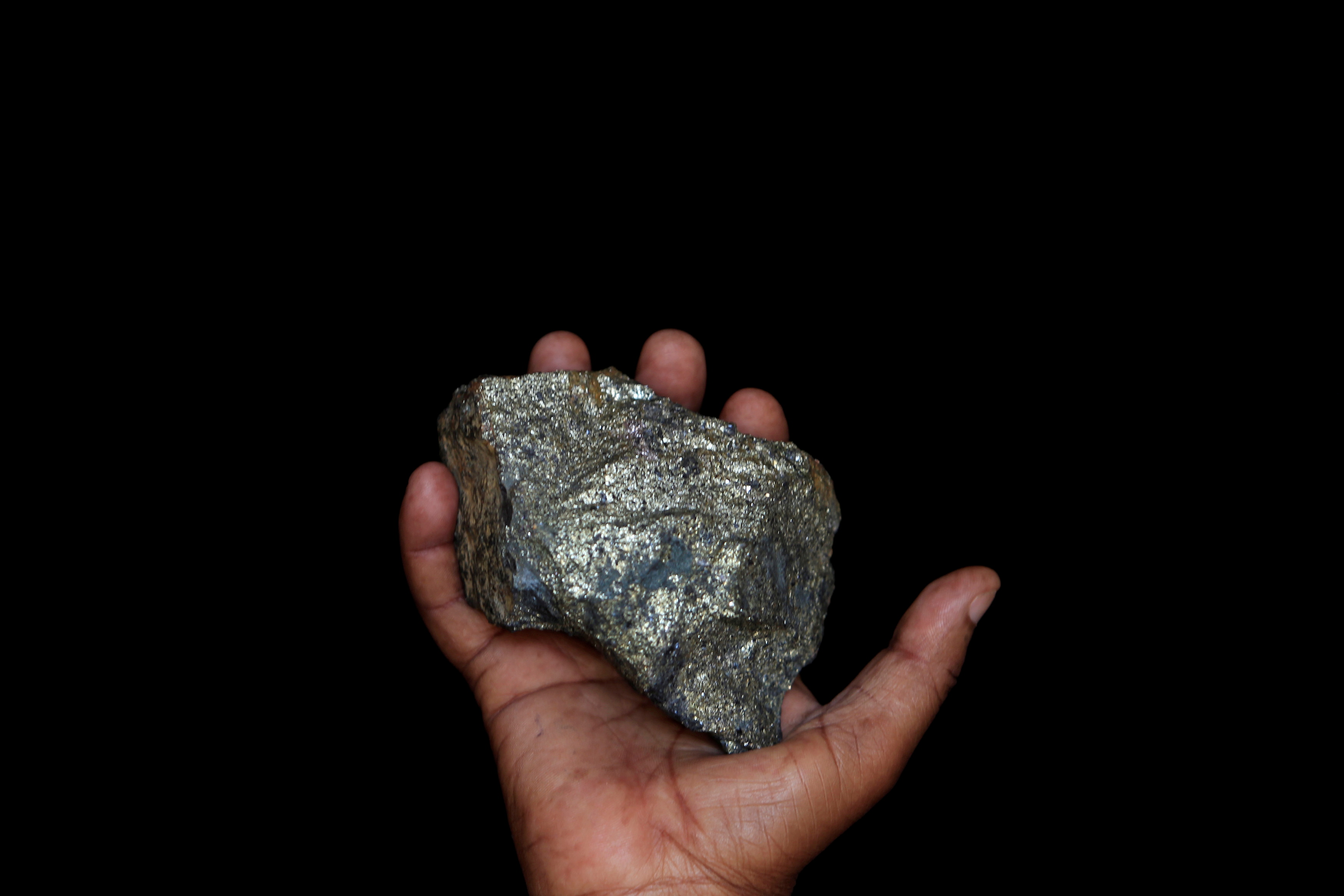 A mine employee shows a piece of copper ore at the Kilembe mines, in the foothills of the Rwenzori Mountains, 497km (309 miles) west of Uganda's capital Kampala, January 31, 2013. 