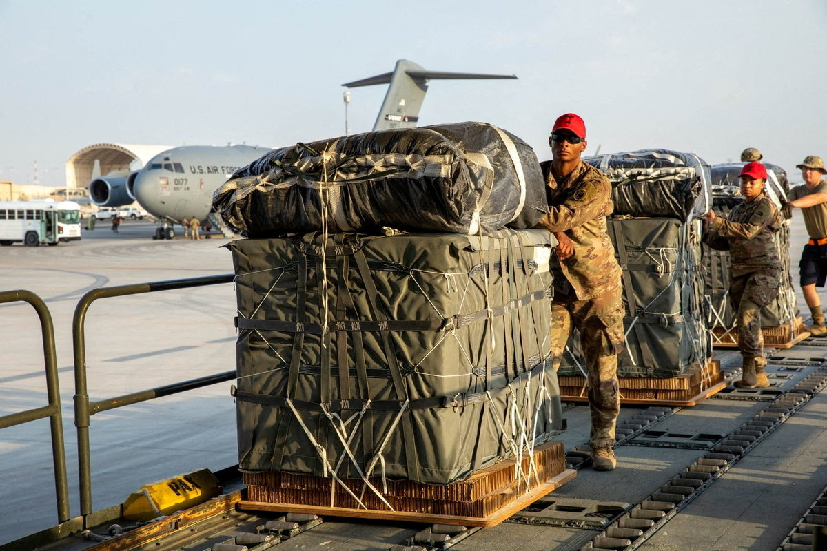 U.S. Air Force members work on the preparation of a humanitarian aid drop for Gaza residents