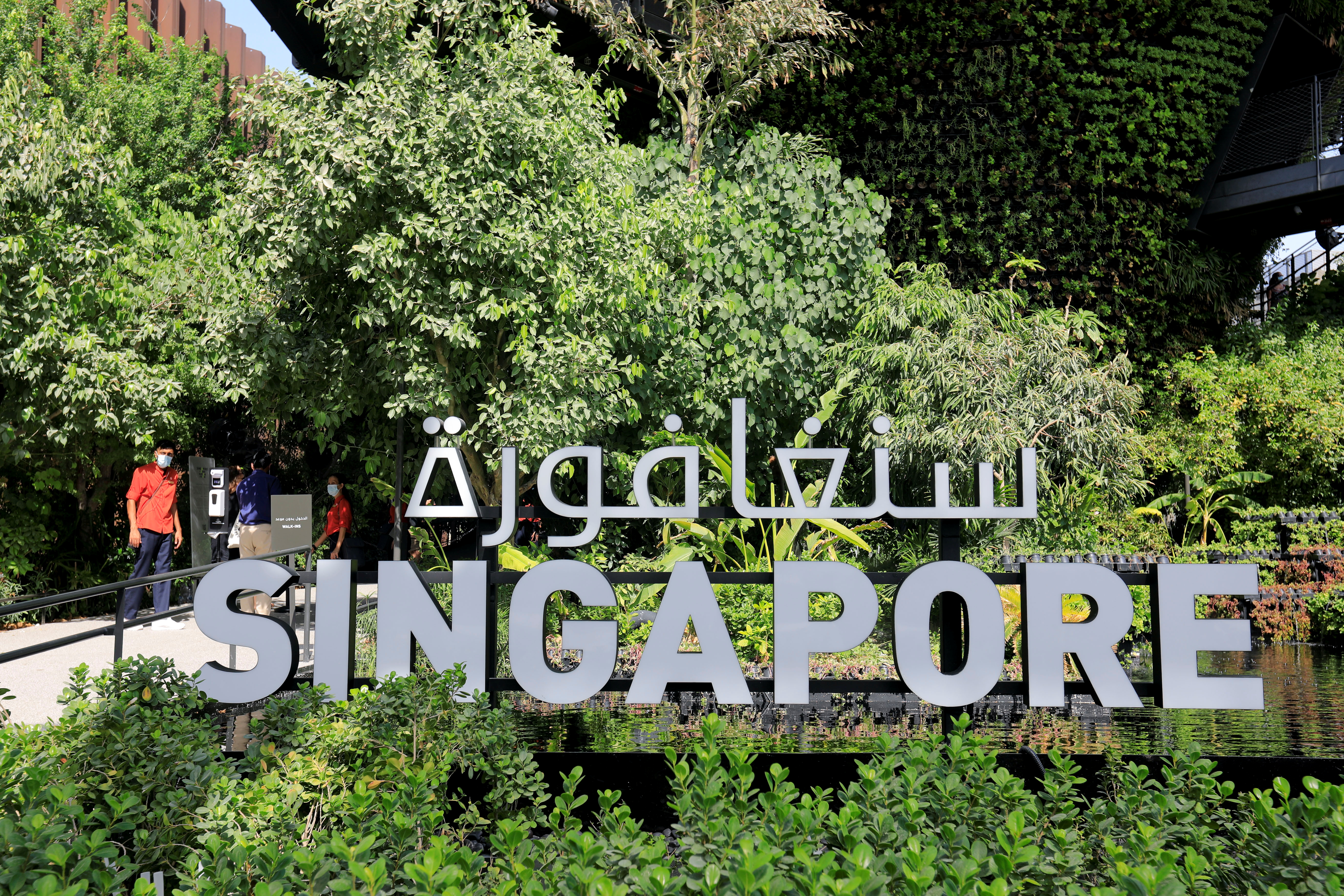 Workers are pictured at the Singapore Pavilion at Dubai Expo 2020 in Dubai