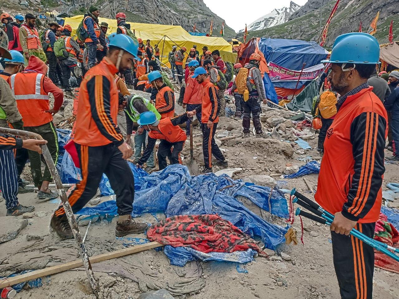 Rescuers search for survivors following a cloudburst near the holy Amarnath cave shrine in Kashmir