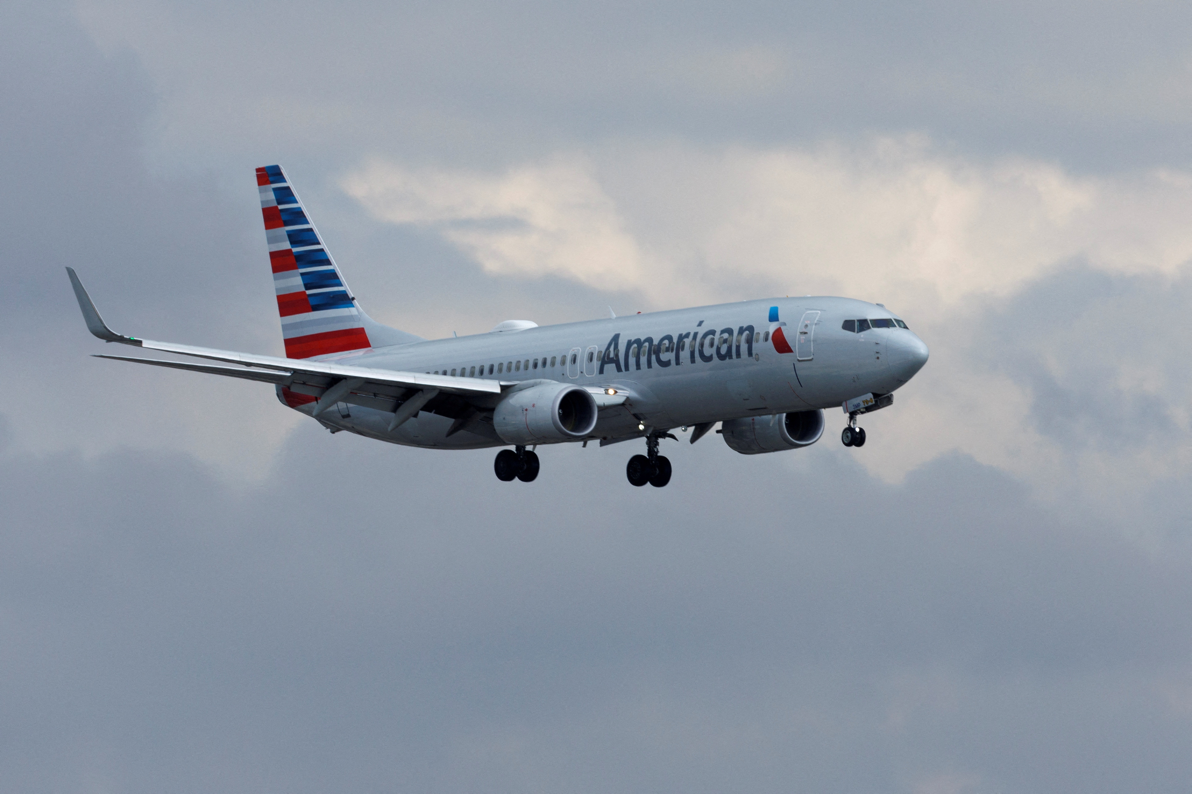 An American Airlines commercial aircraft approaches to land at John Wayne Airport in Santa Ana, California