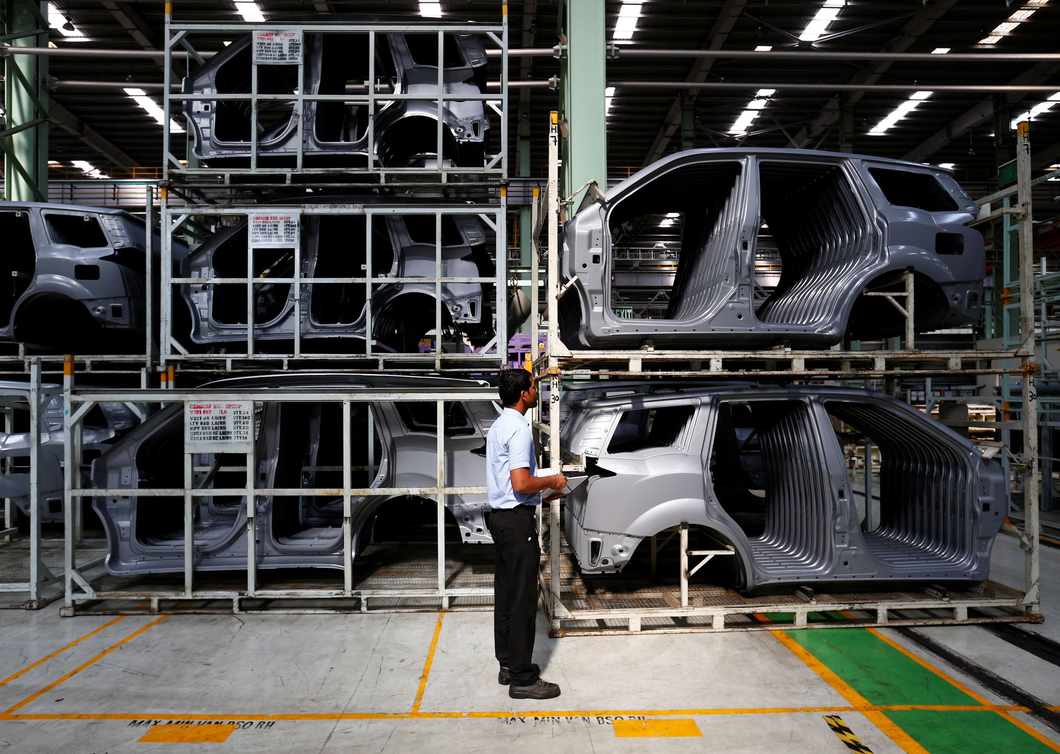 An employee works inside the Mahindra & Mahindra manufacturing plant in Chakan