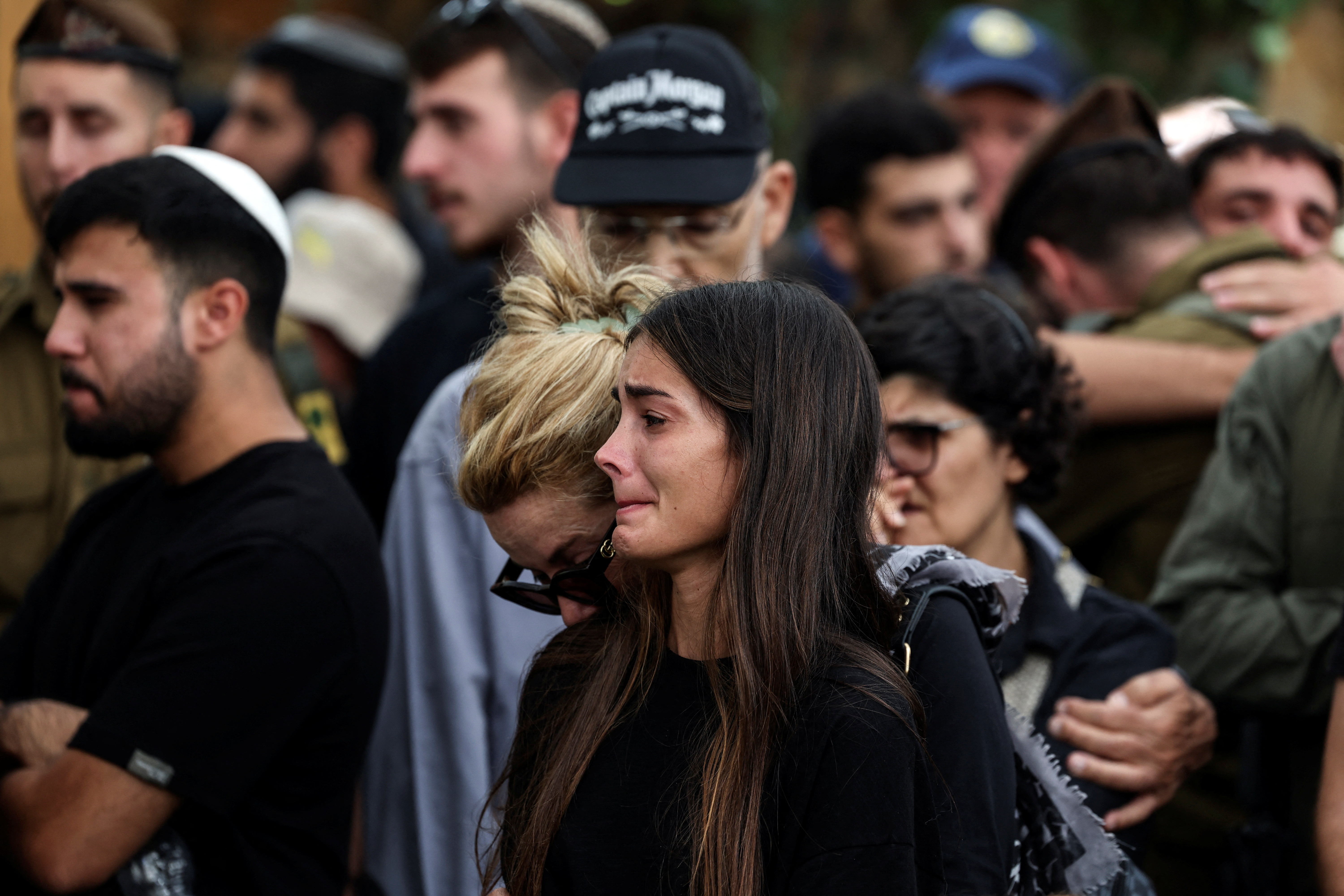 People mourn Adi Zur, a soldier who was slain in the assault on Israel by Hamas gunmen from the Gaza Strip, at their funeral at Mount Herzl Military Cemetery in Jerusalem