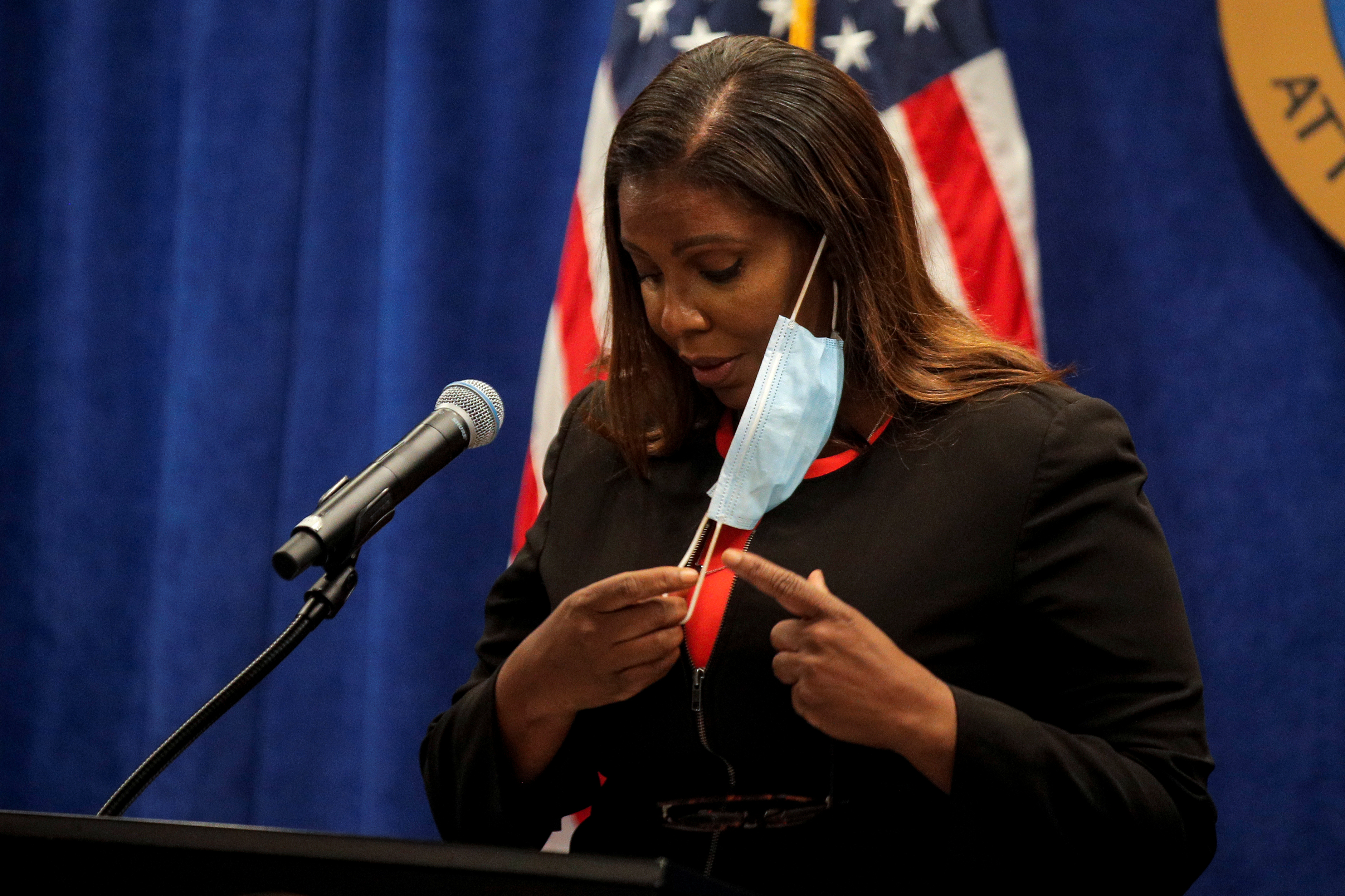 New York State Attorney General, Letitia James, removes her mask to start a news conference, to announce a suit to dissolve the National Rifle Association, In New York