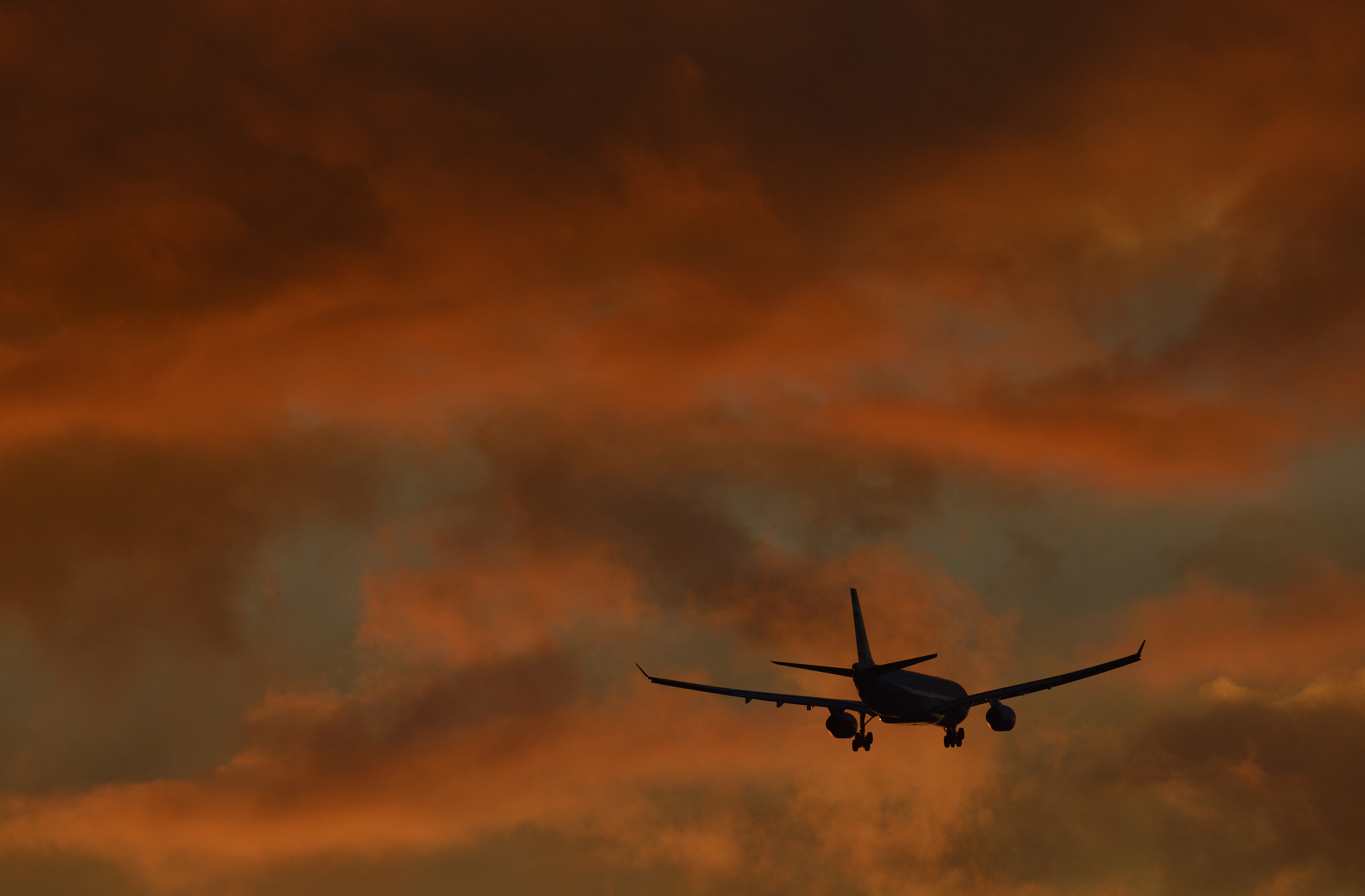 A passenger plane flies in to land at Heathrow Airport in west London