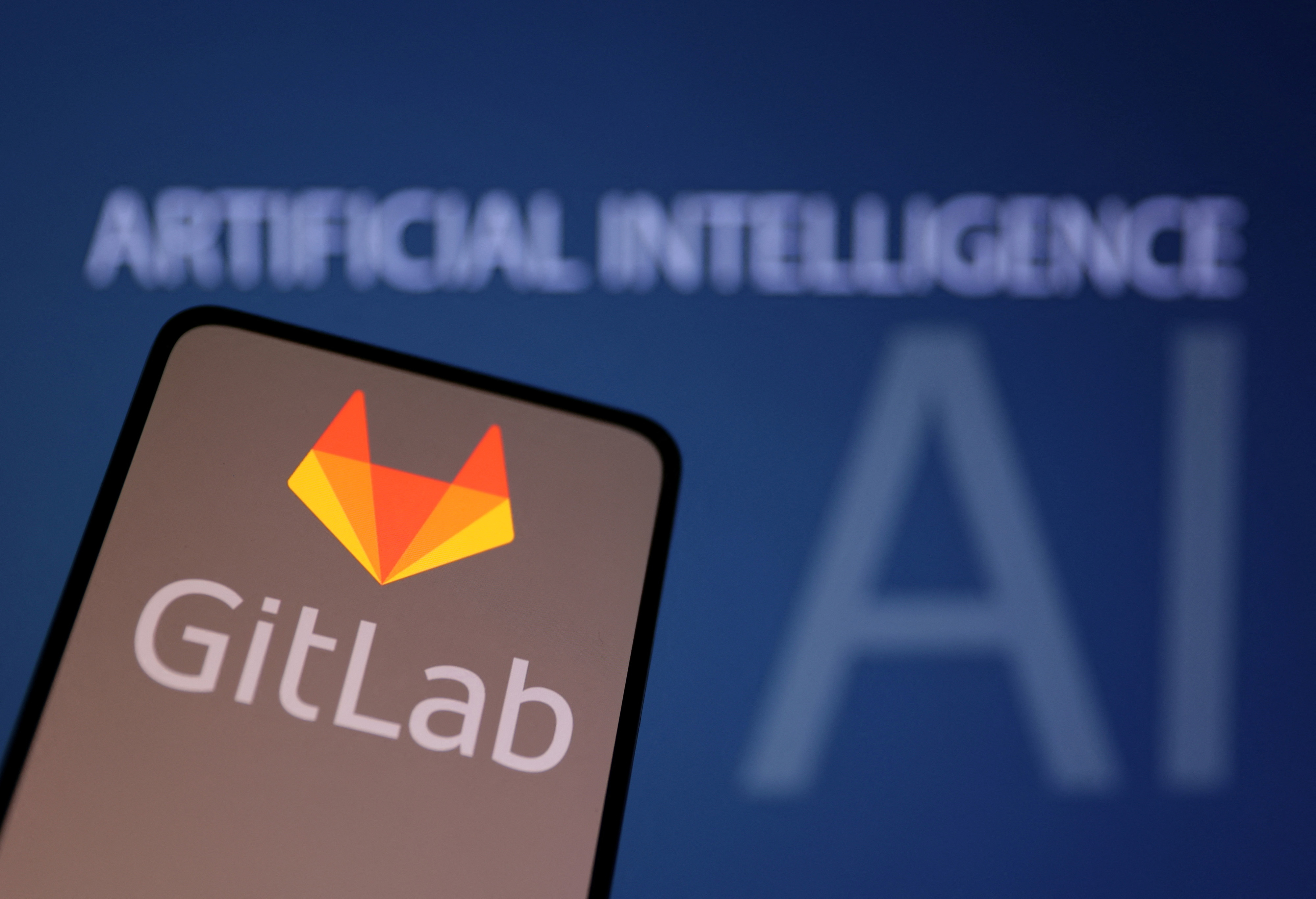 Illustration shows GitLab Inc logo and words 'Artificial Intelligence'