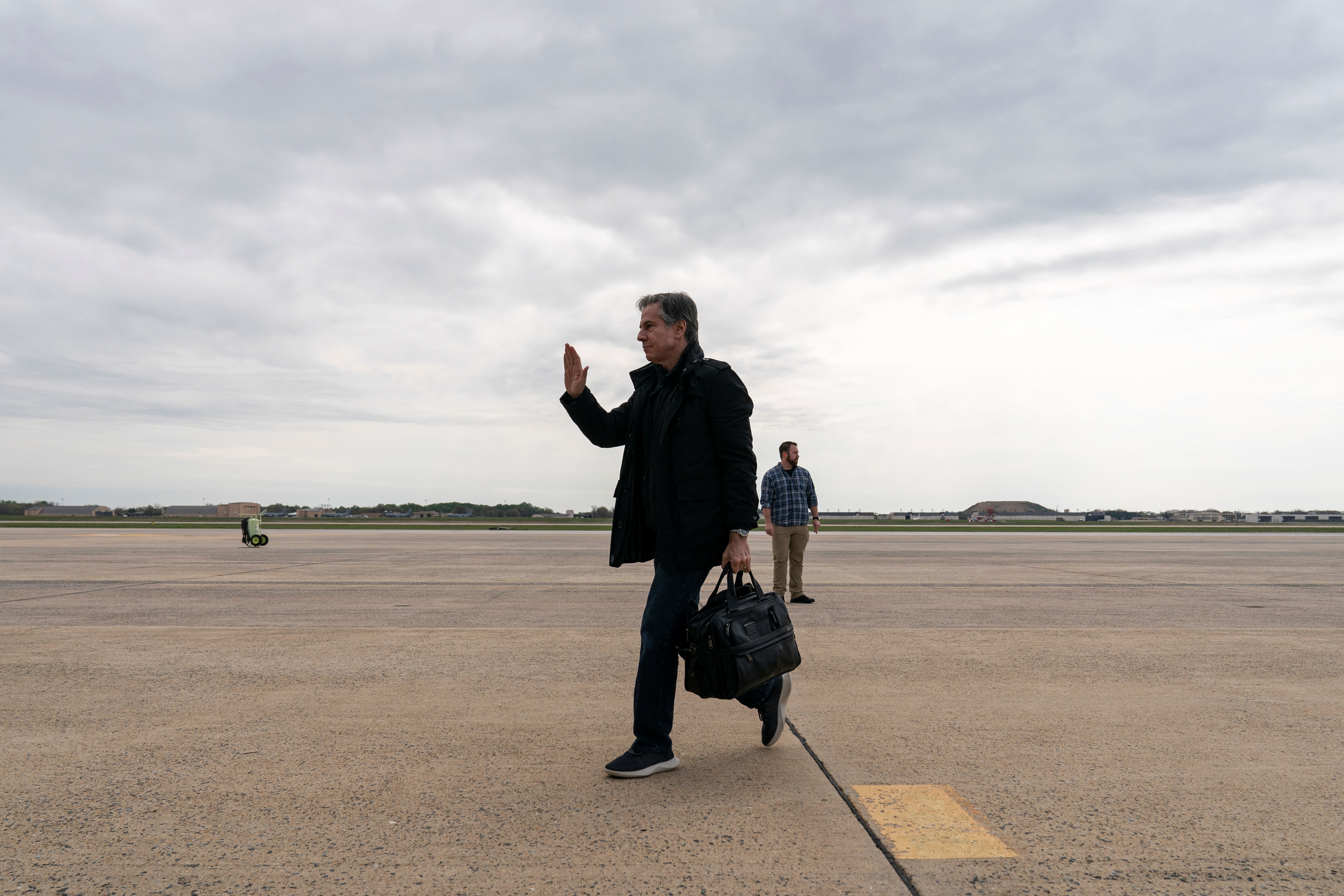 U.S. Secretary of State Antony Blinken waves as he departs from Joint Base Andrews, in Maryland