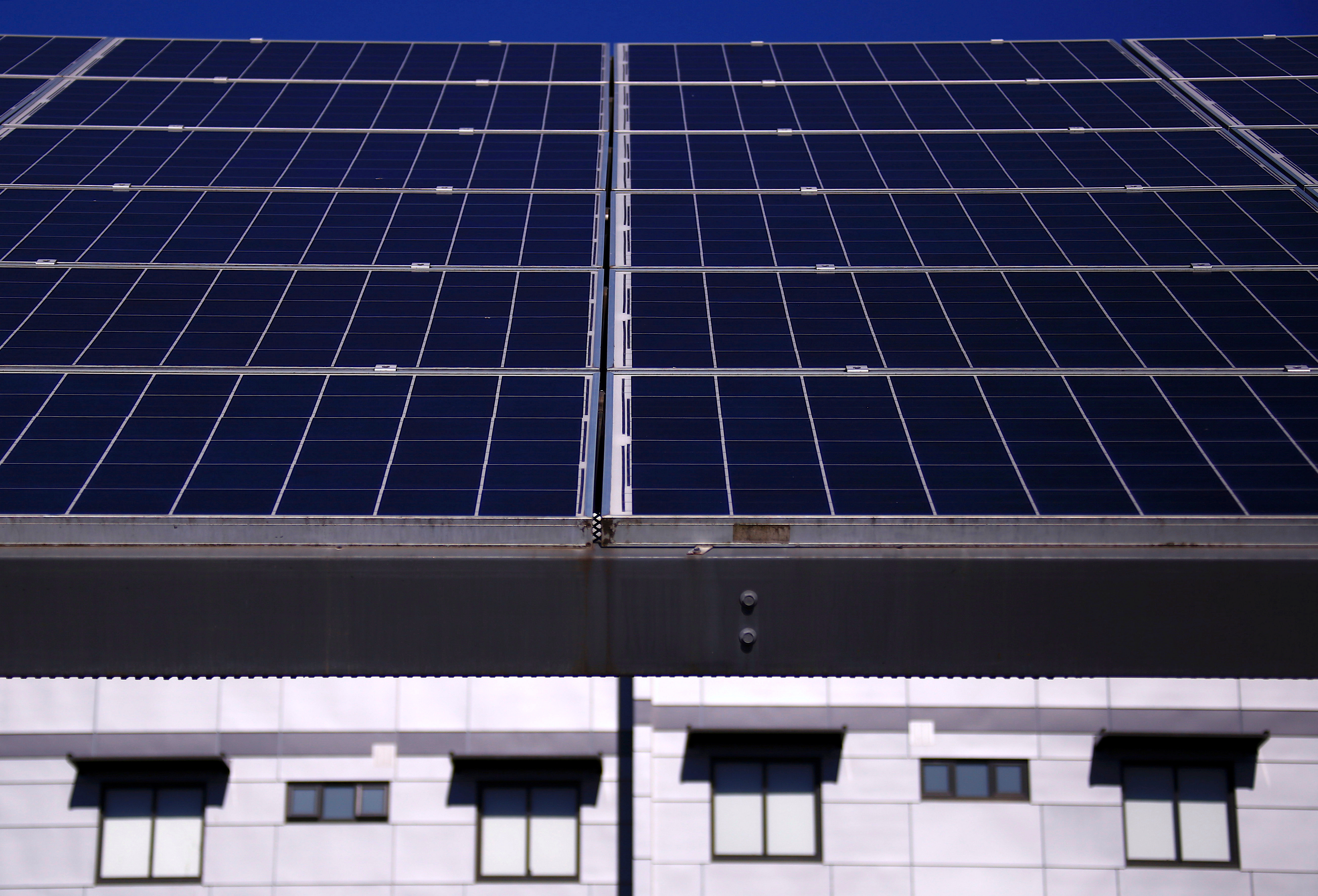 A solar array, a linked collection of solar panels, can be seen in front of a residential apartment block in the Sydney suburb of Chatswood in Australia