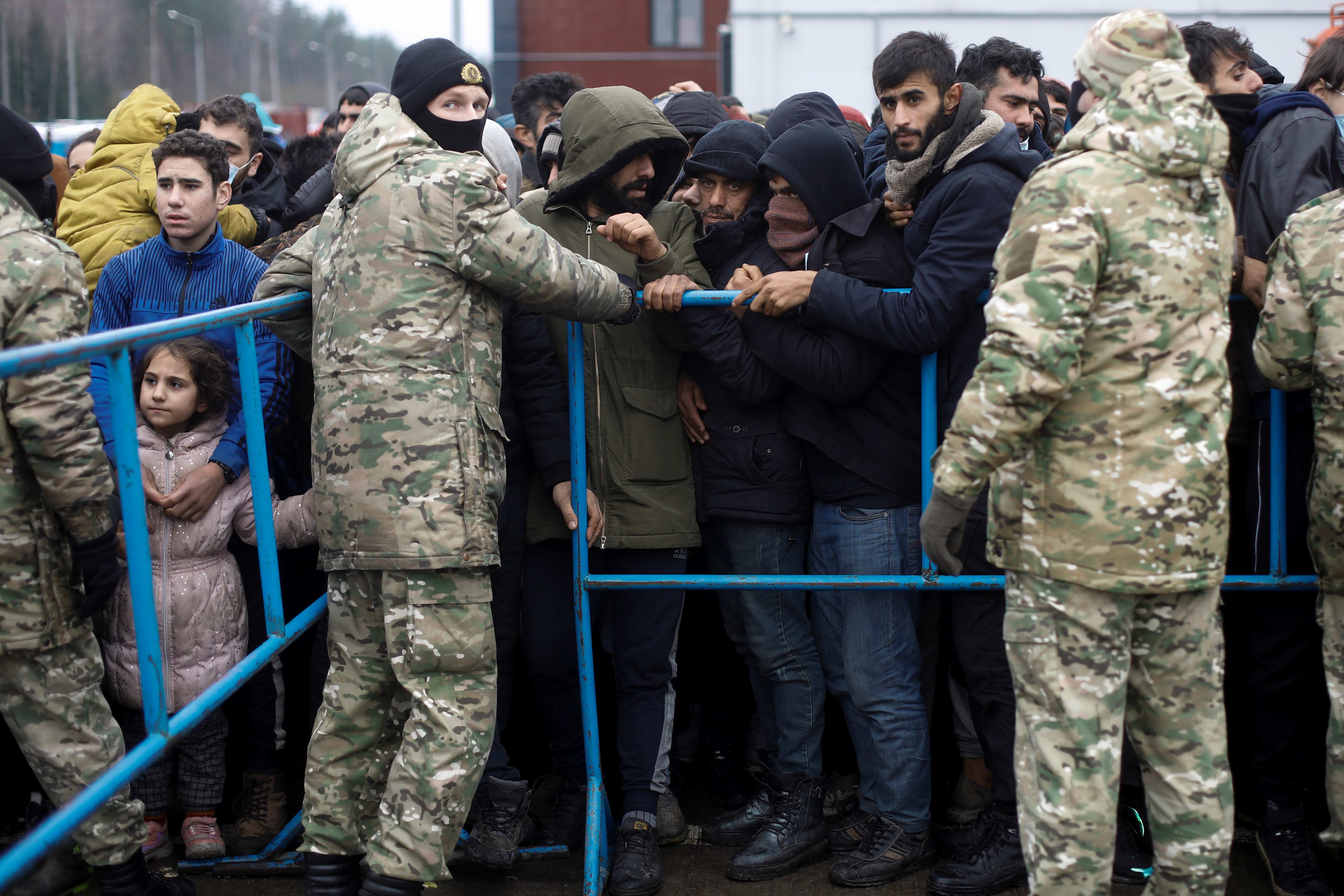 Migrants gather to receive food near the Belarusian-Polish border in the Grodno region