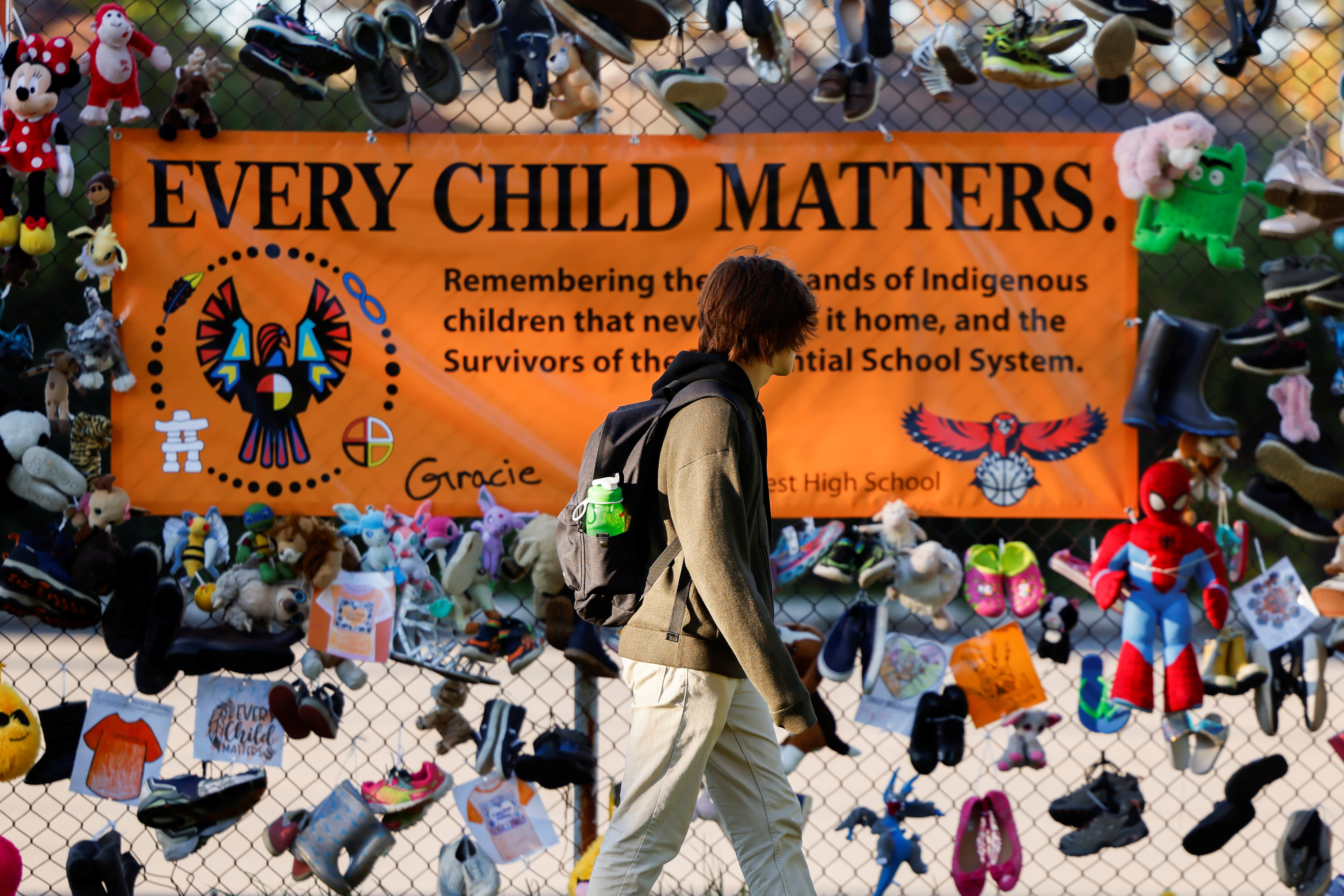 A student walks past a display at Hillcrest High School on Canada's first National Day for Truth and Reconciliation, honouring the lost children and survivors of Indigenous residential schools, their families and communities, in Ottawa, Ontario, Canada September 30, 2021. REUTERS/Blair Gable