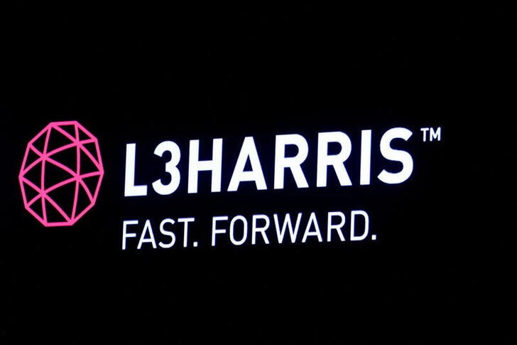 The logo of L3Harris is displayed on a screen on the floor of the NYSE in New York