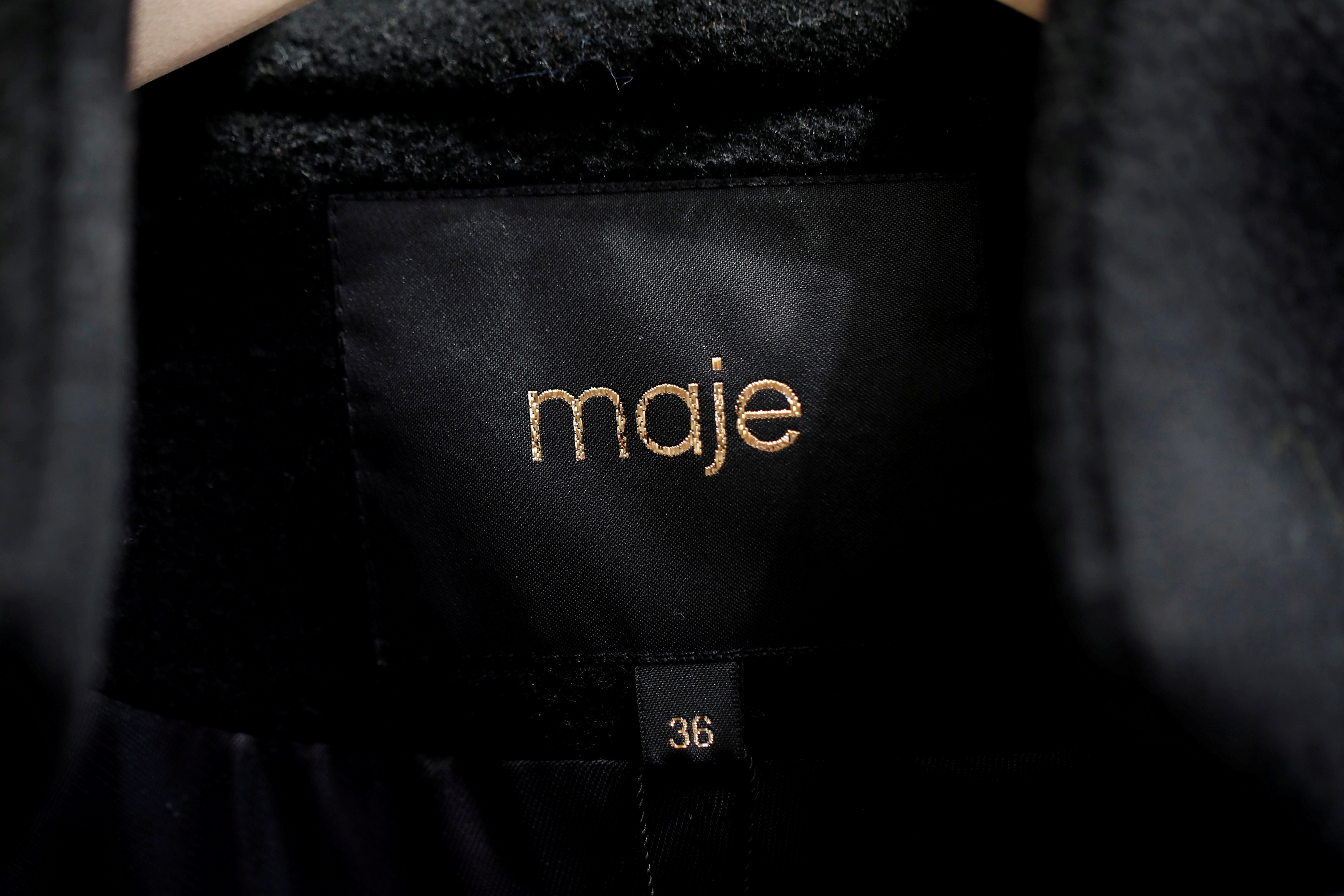 A Maje label is pictured on clothes inside a Maje luxury clothing store, operated by SMCP Group, in Paris