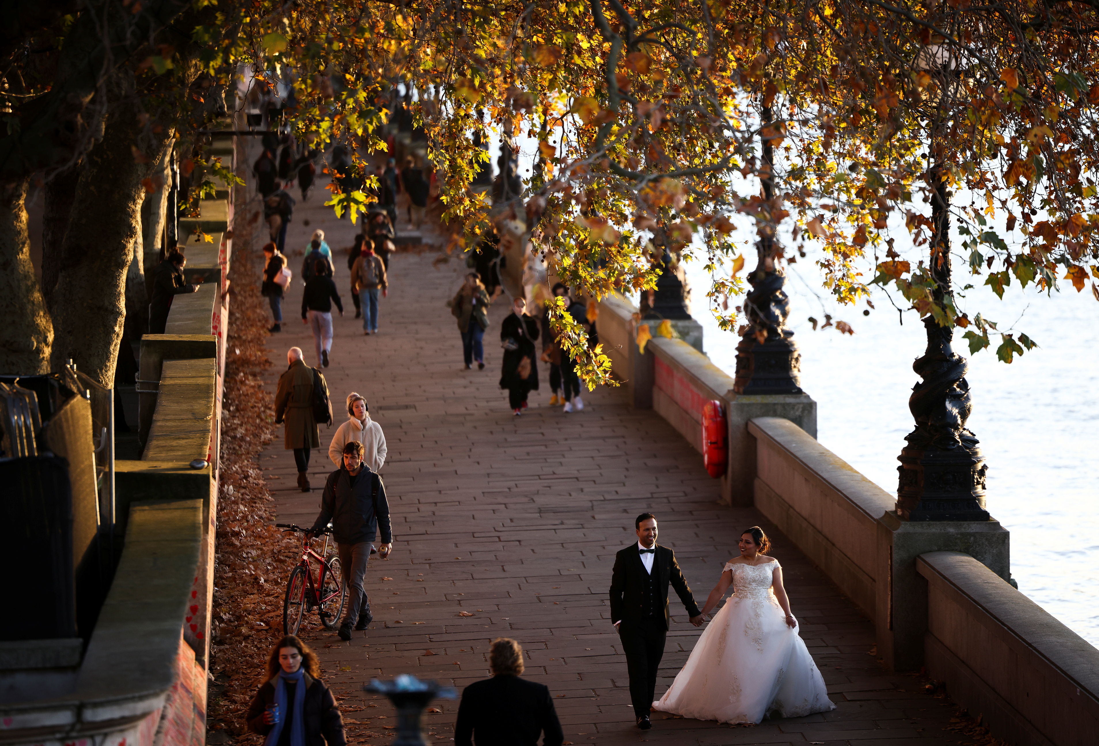 People walk along the South Bank in London
