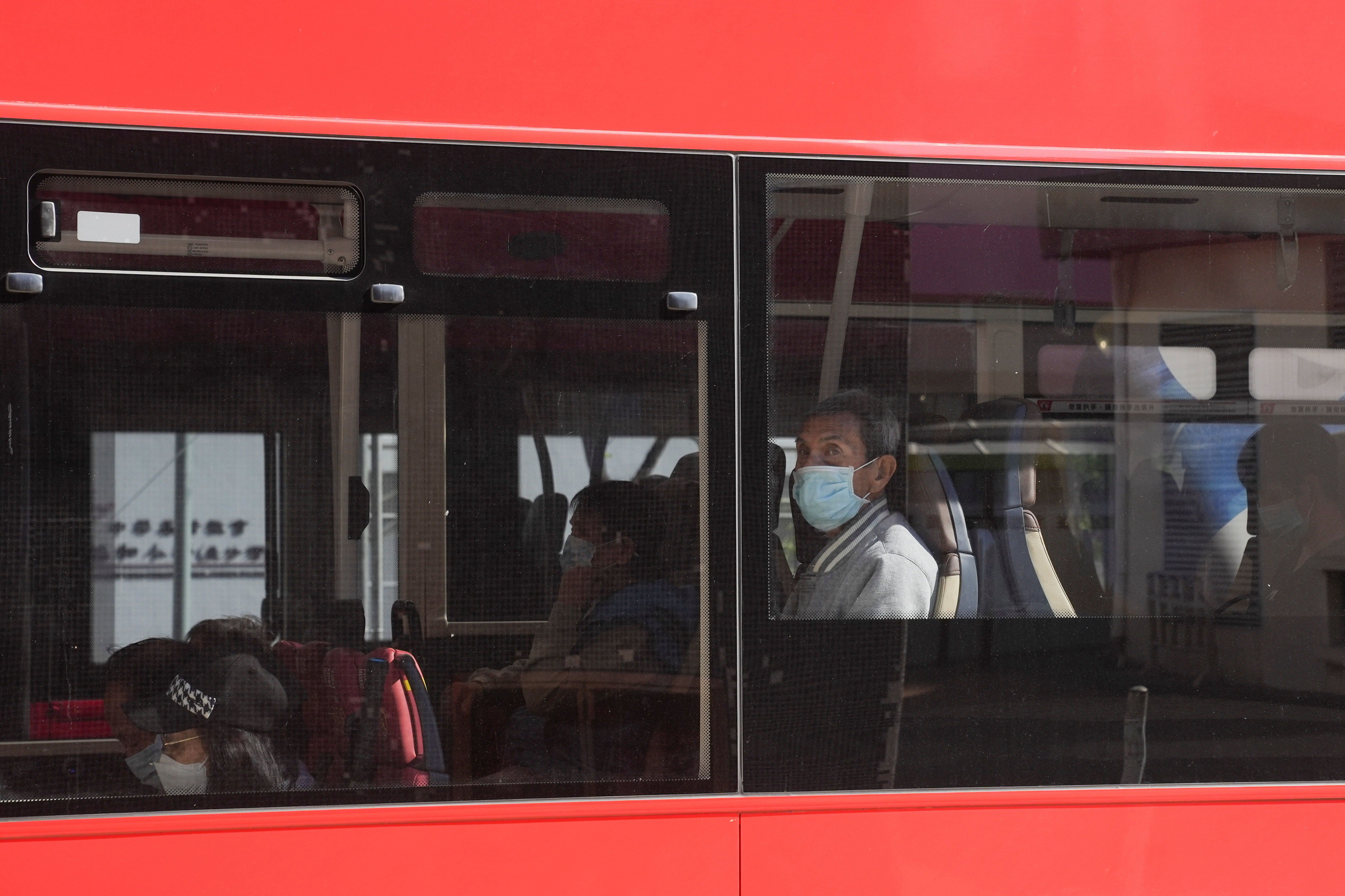 People wearing face masks to prevent the spread of the coronavirus disease (COVID-19), ride in a bus in Hong Kong