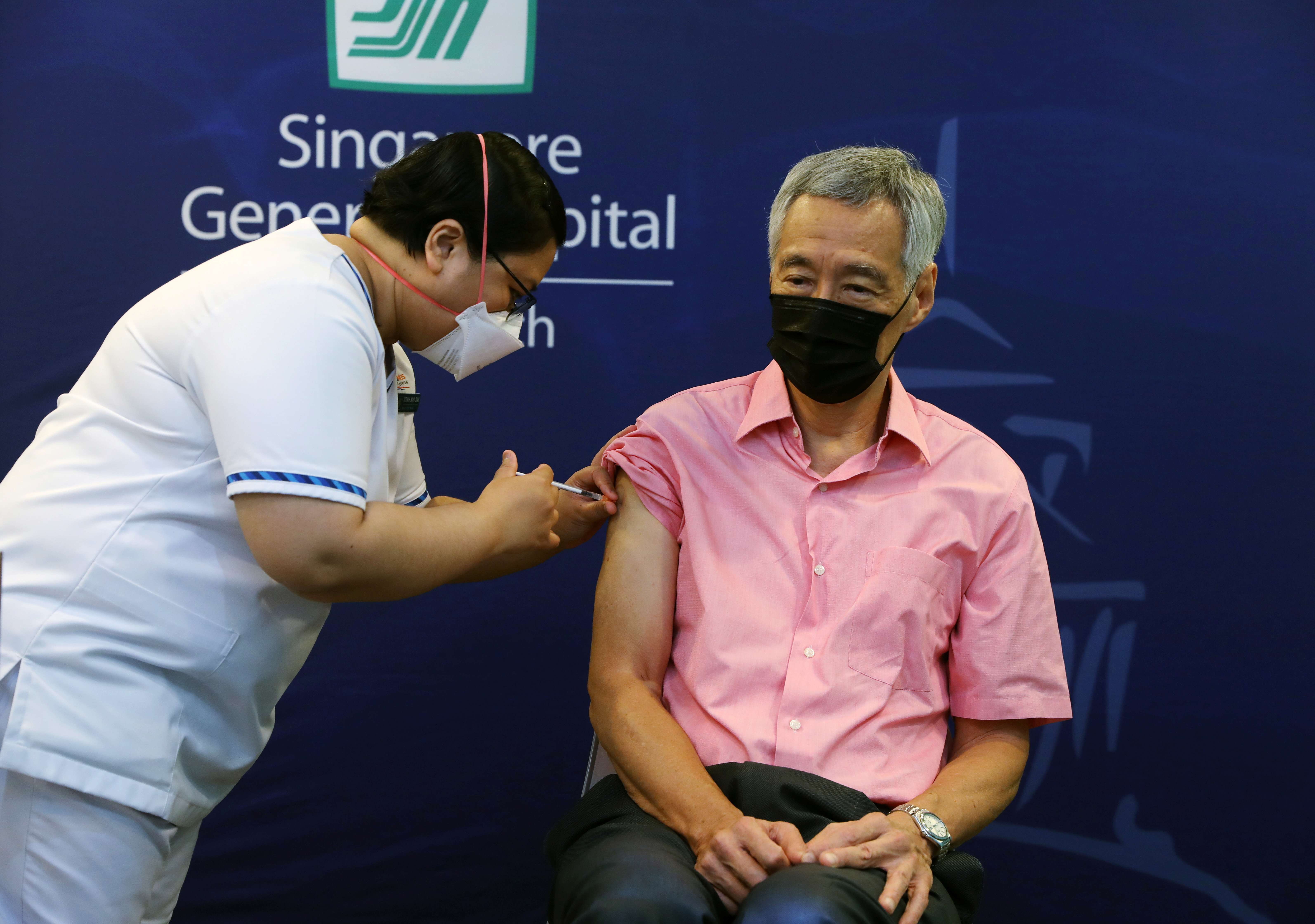 Singapore's Prime Minister Lee Hsien Loong receives a booster shot of coronavirus disease (COVID-19) vaccine at the Singapore General Hospital