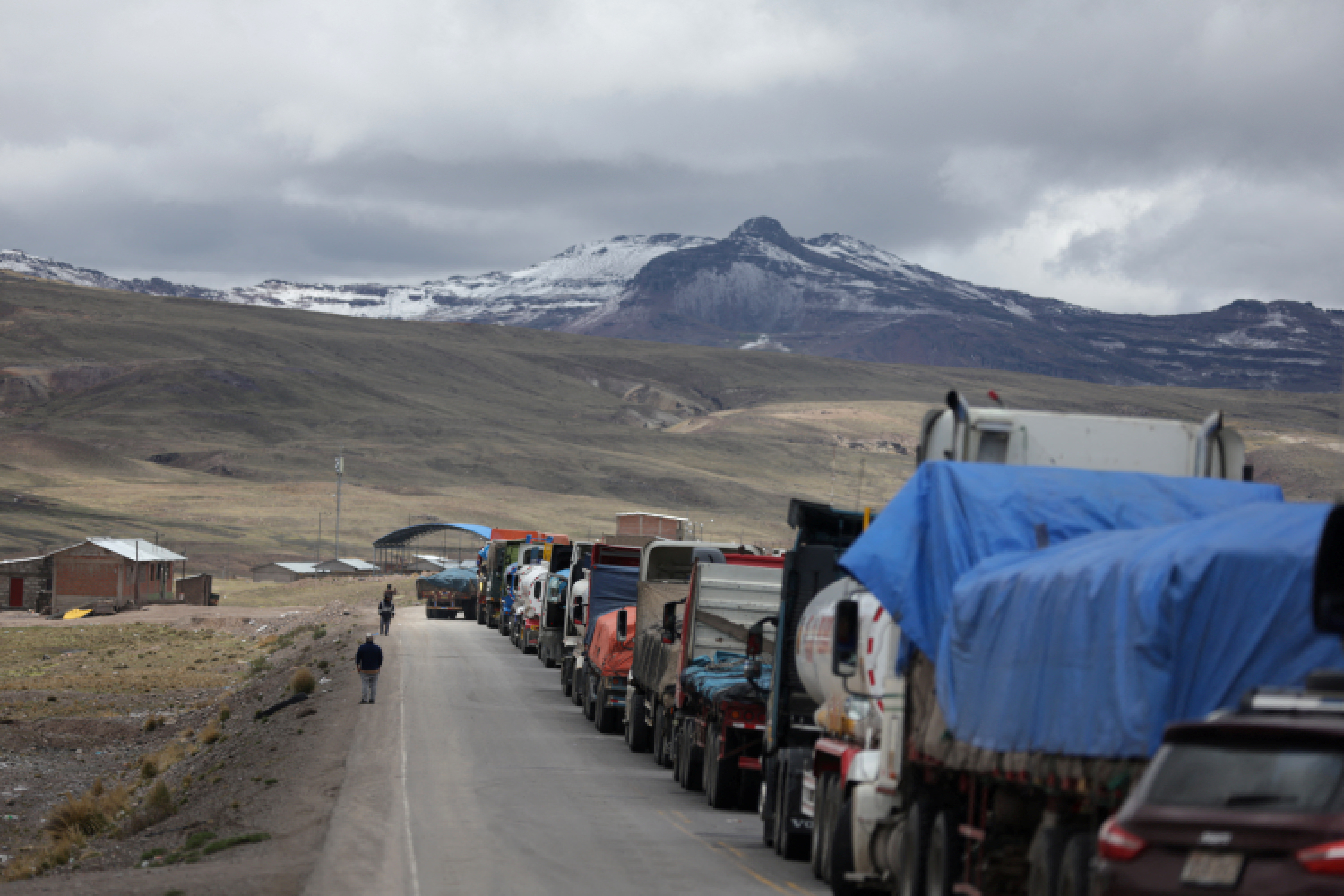 Trucks remain stuck during a roadblock caused due to a demonstration by anti-government protestors, in Condoroma