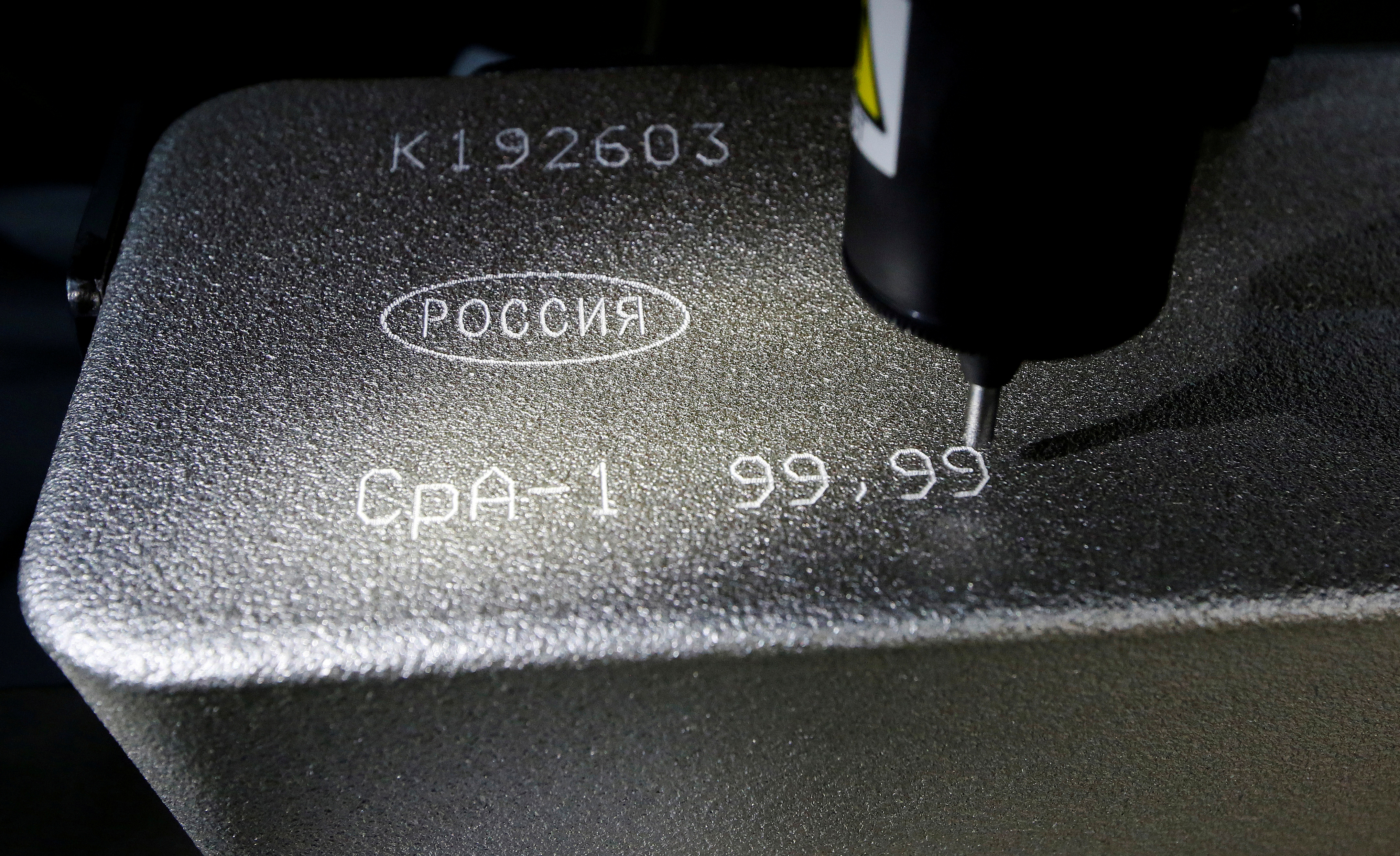 Machine engraves information on 99.99 percent pure silver ingot at Krastsvetmet non-ferrous metals plant in Krasnoyarsk