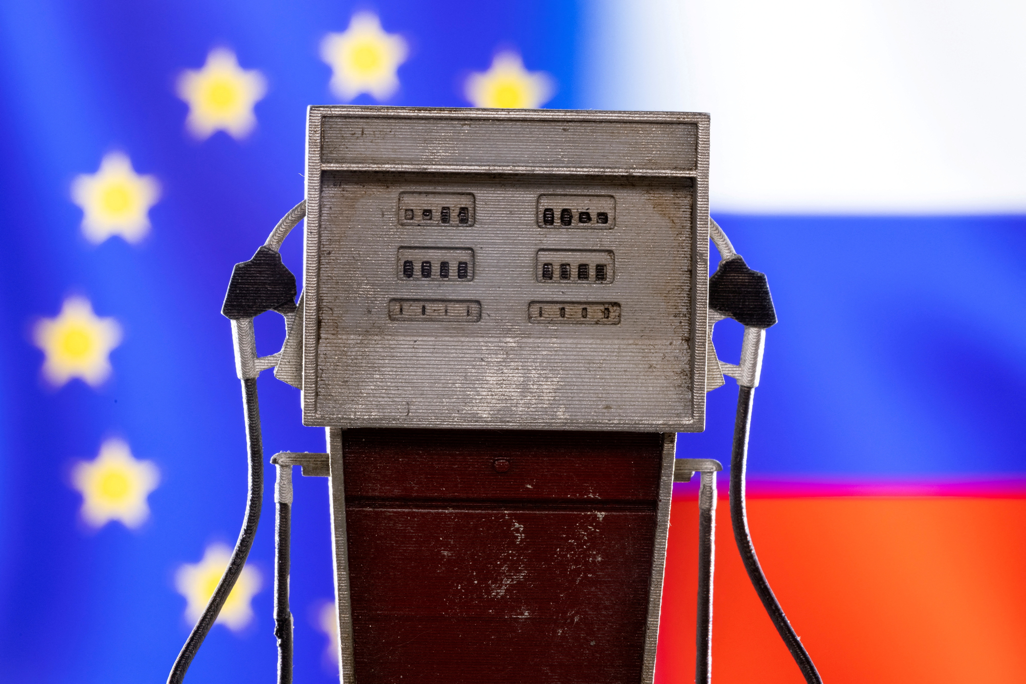 Illustration shows model of petrol pump, EU and Russian flag colors