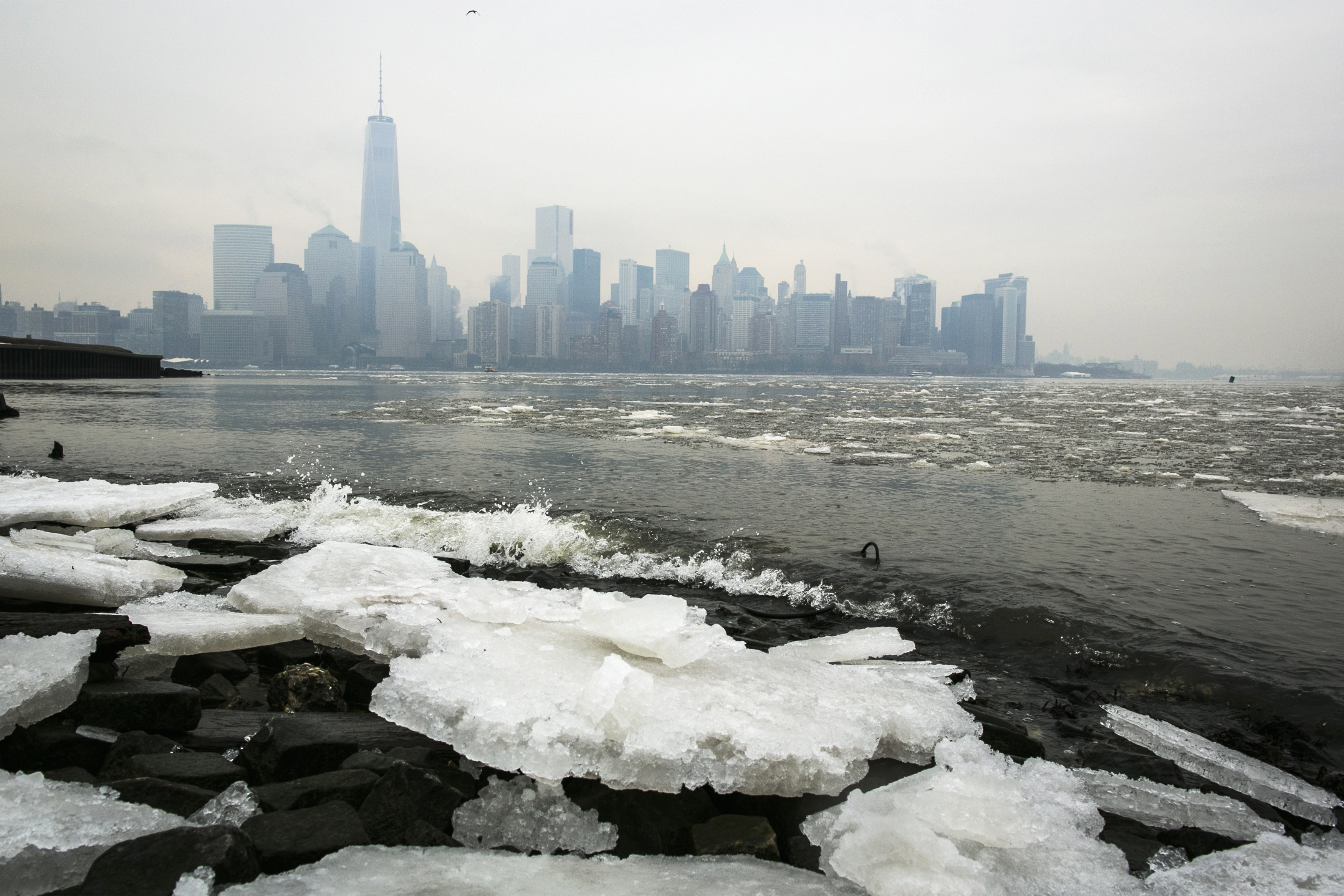 Ice lines the shoreline of the Hudson River as the New York City skyline is seen from Jersey City, New Jersey