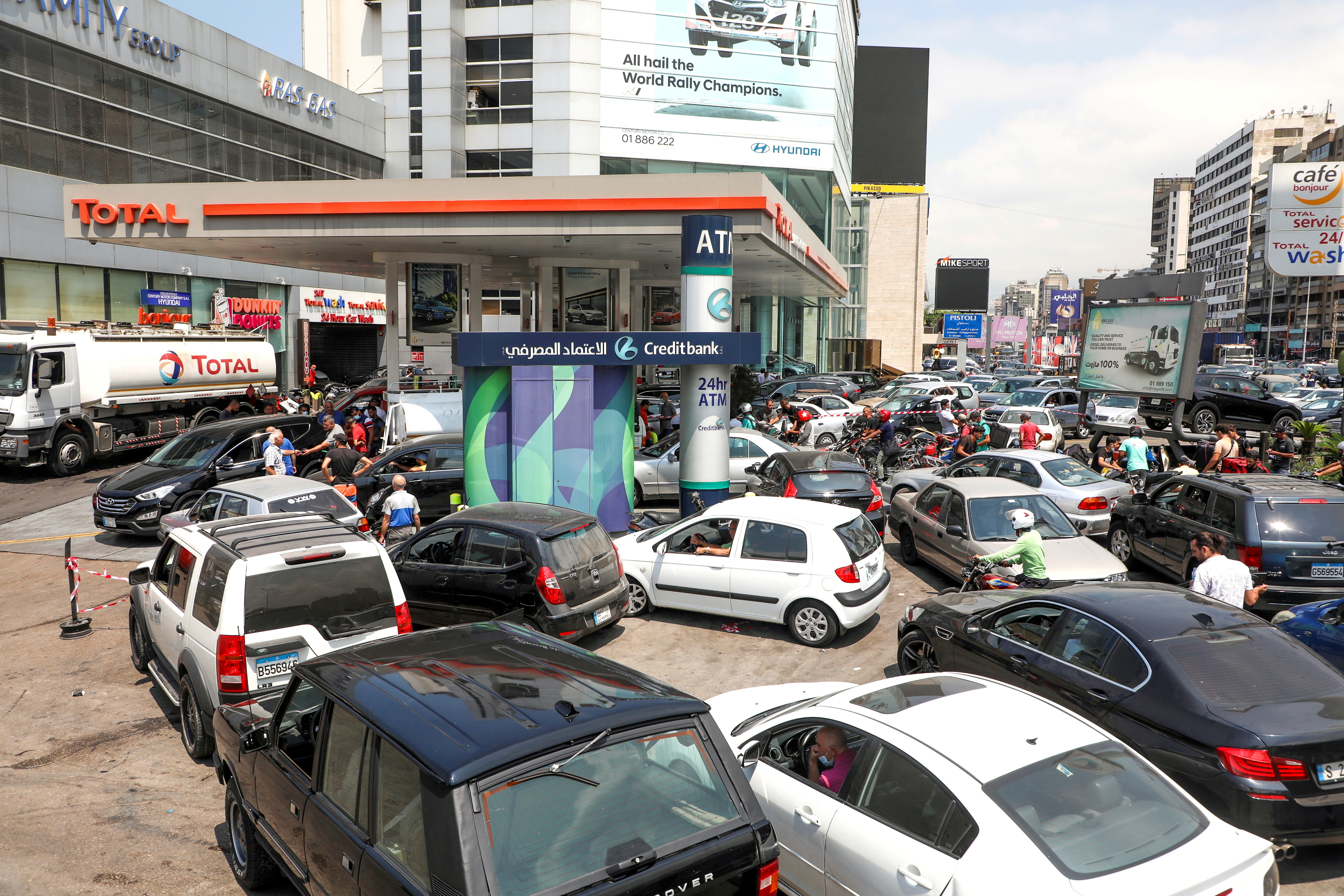 People wait in cars to get fuel at a gas station in Zalka, Lebanon
