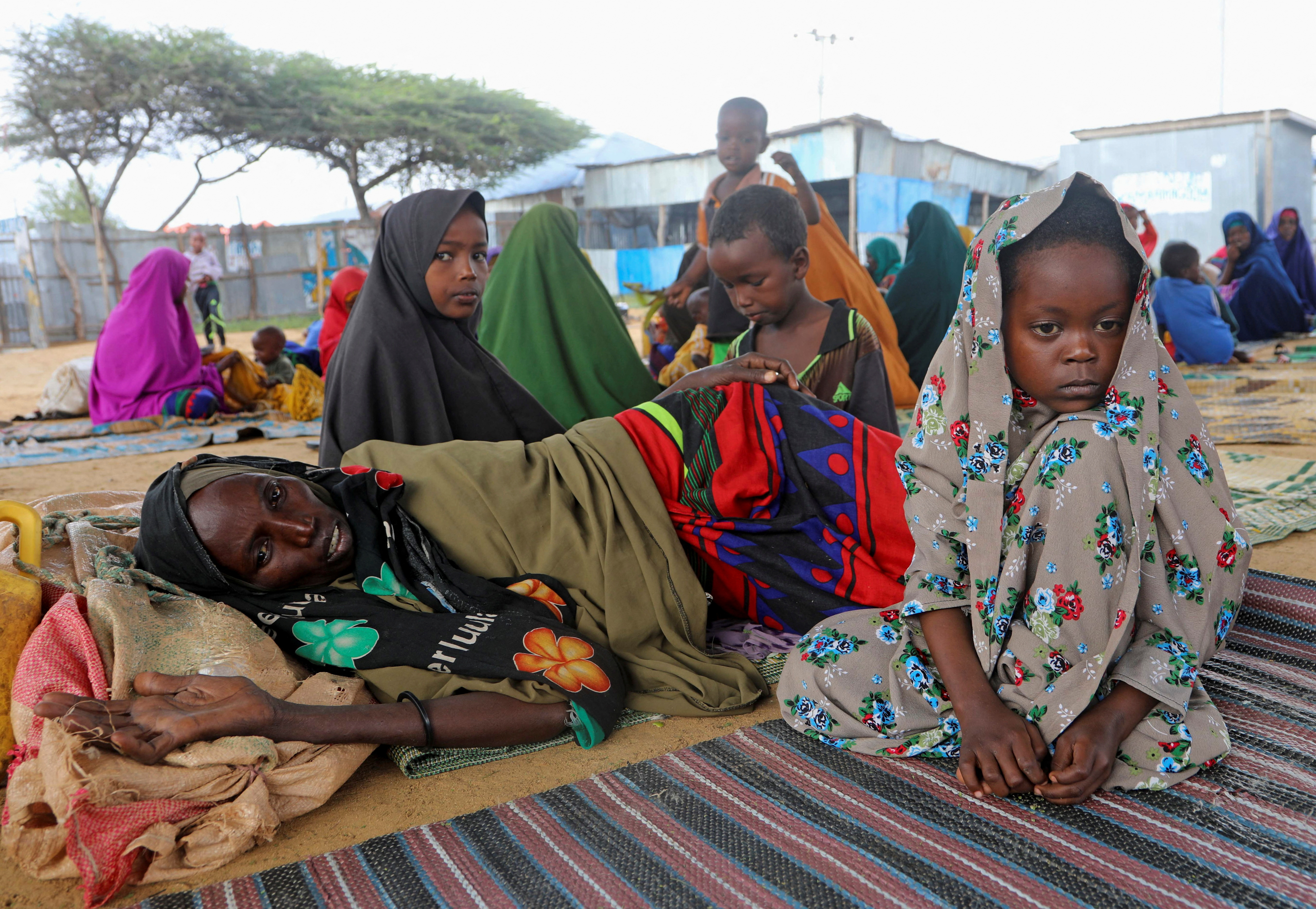 People affected by the worsening drought due to failed rain seasons, look on, at the Alla Futo camp for internally displaced people, in the outskirts of Mogadishu