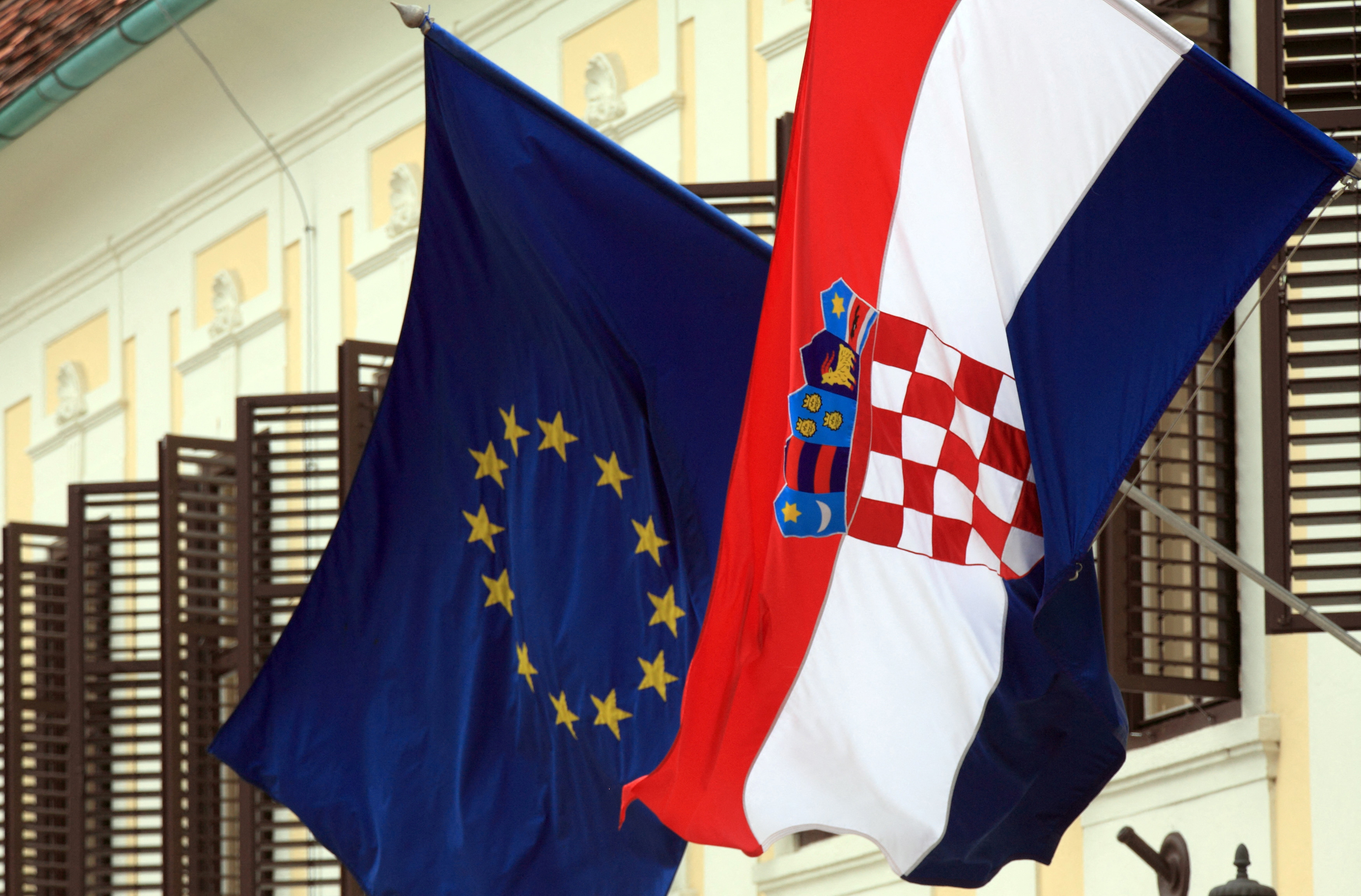 Flags of Croatia and the European Union are seen on the government's building in Zagreb