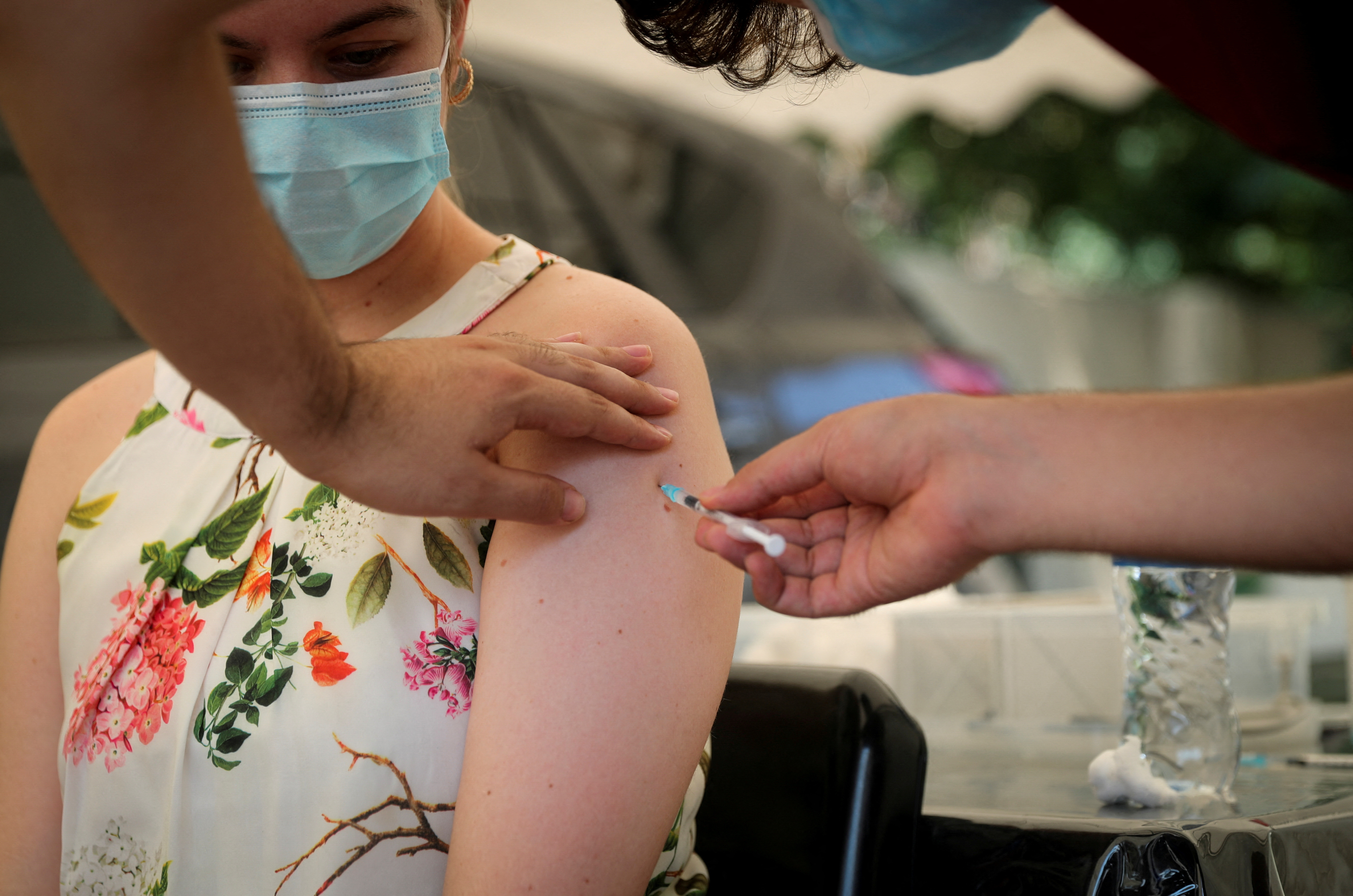 Healthcare worker administers the coronavirus disease (COVID-19) vaccine to a woman, in Johannesburg