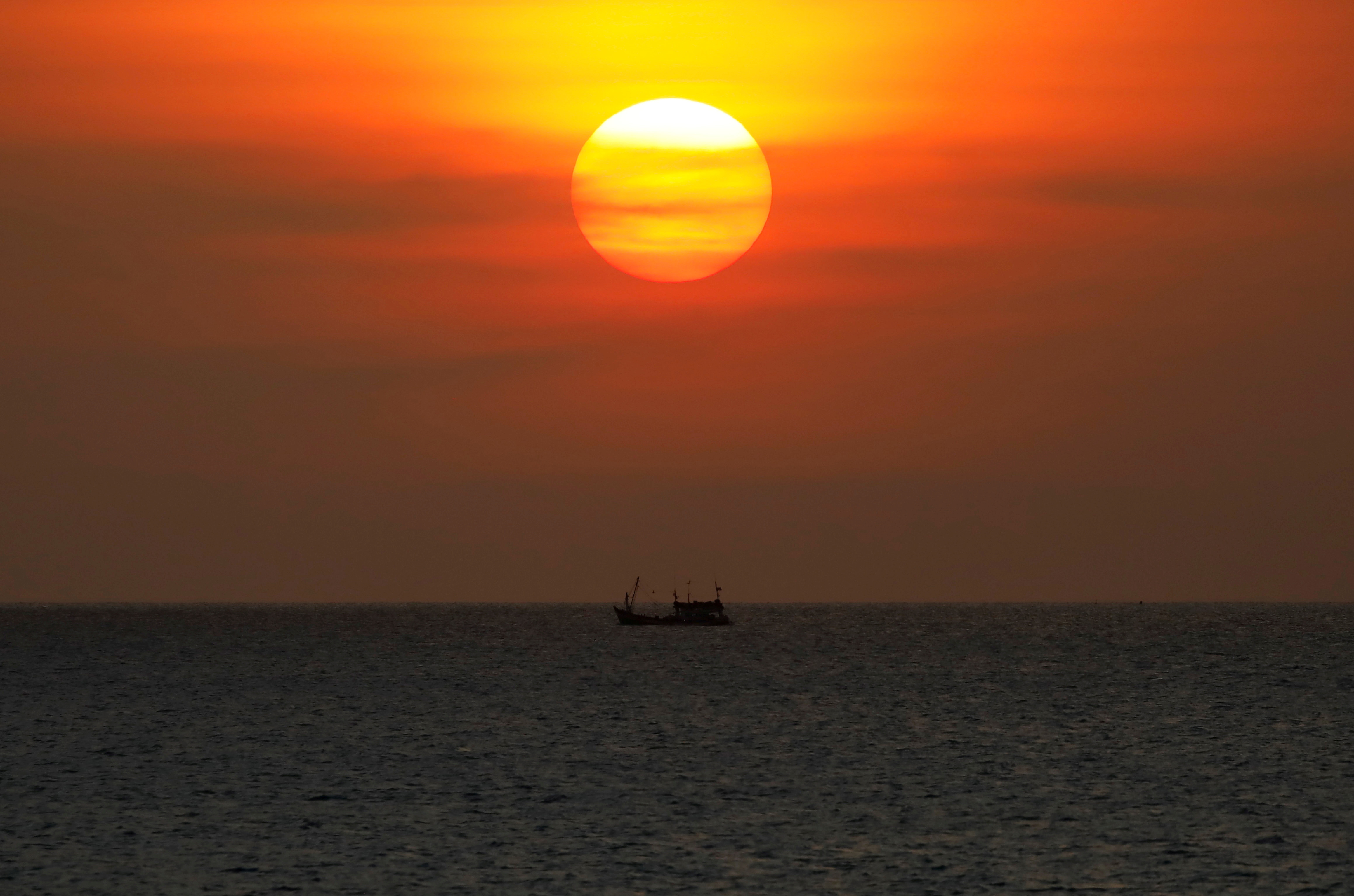 A boat sails on the Gulf Of Thailand during the sunset at Ko Samui in Thailand