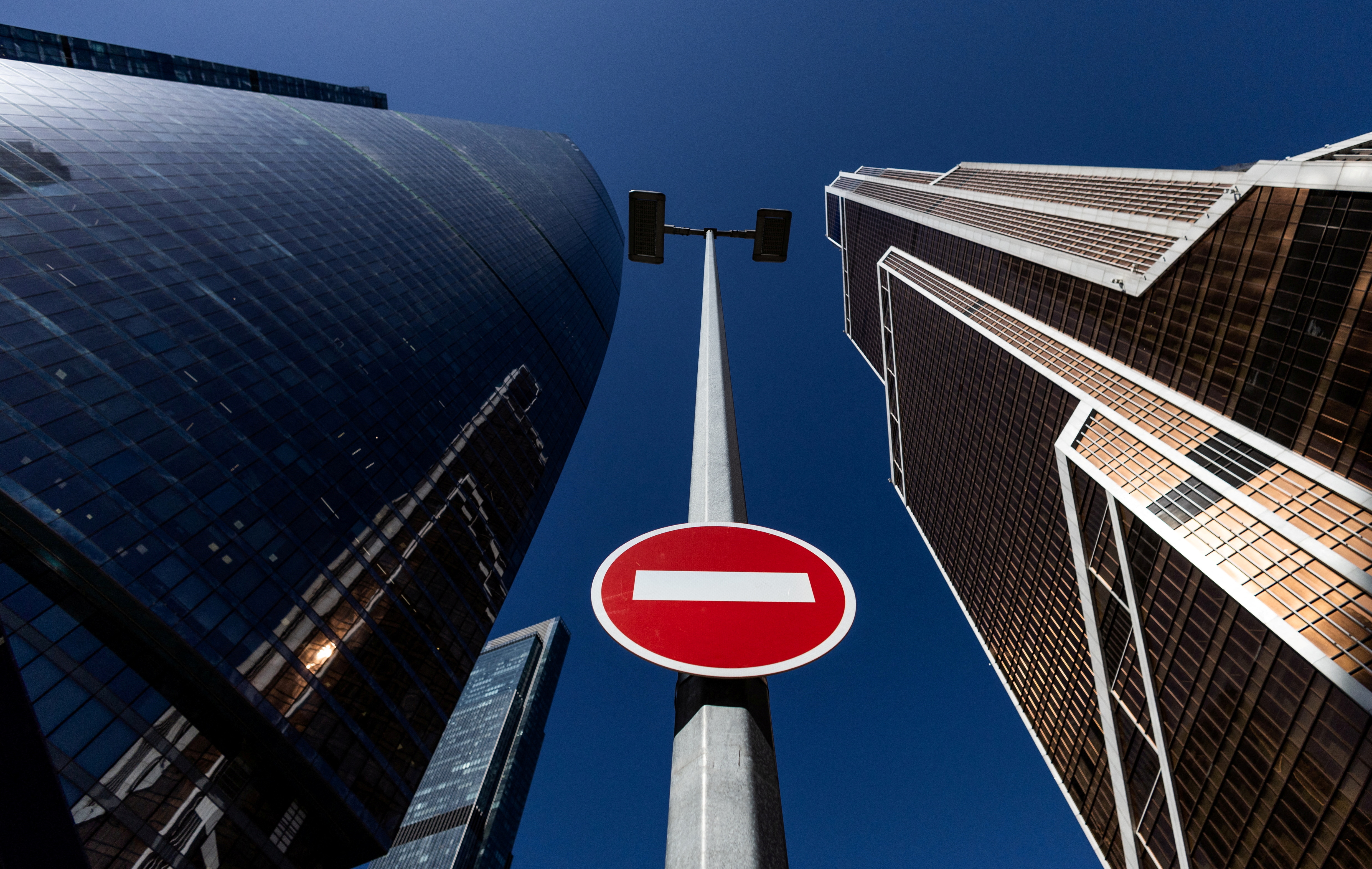 A stop road sign is seen next to skyscrapers at Moscow International business centre, also known as 