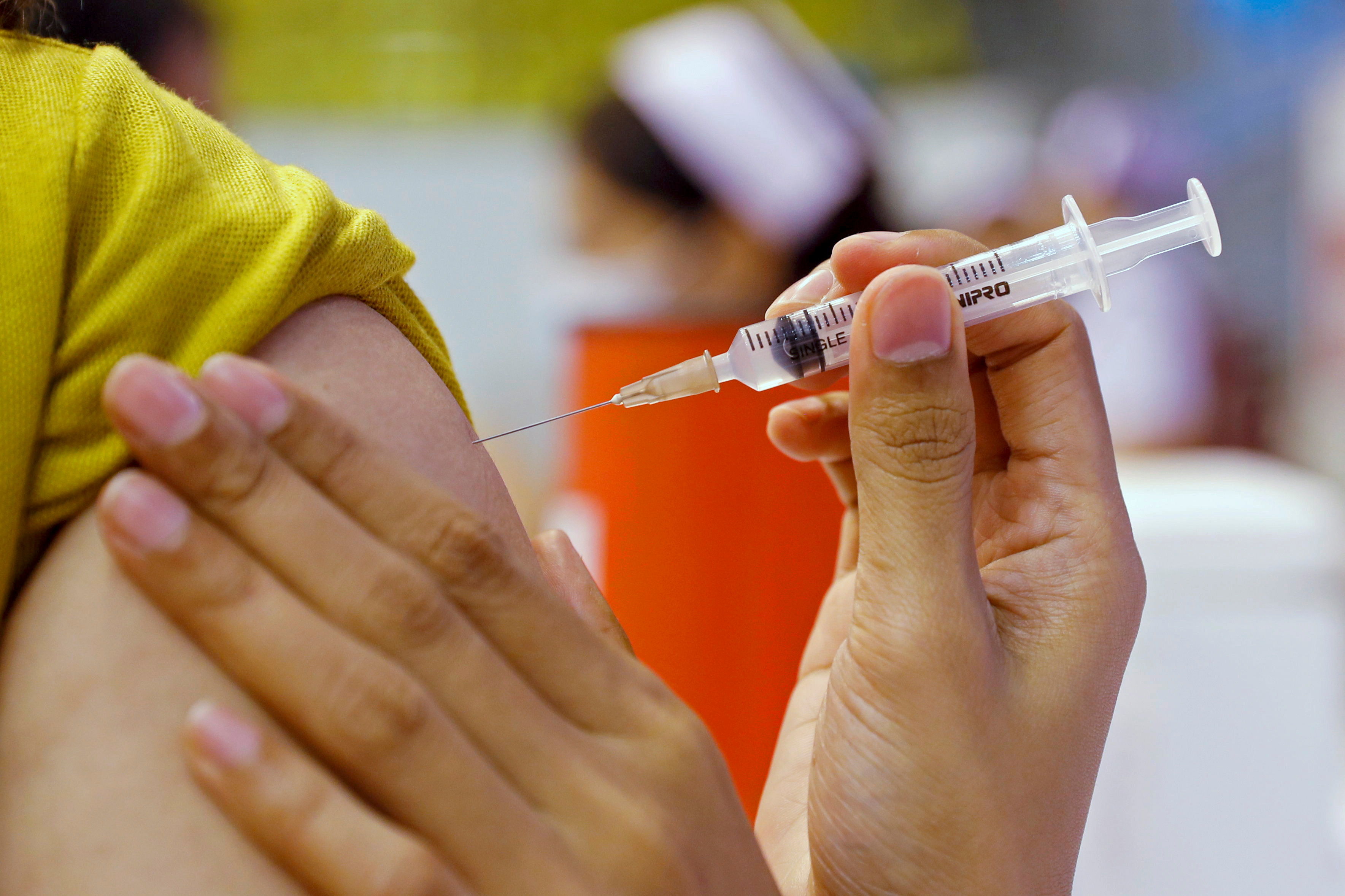 People receive the Sinovac COVID-19 vaccine at the Thai resort island of Phuket