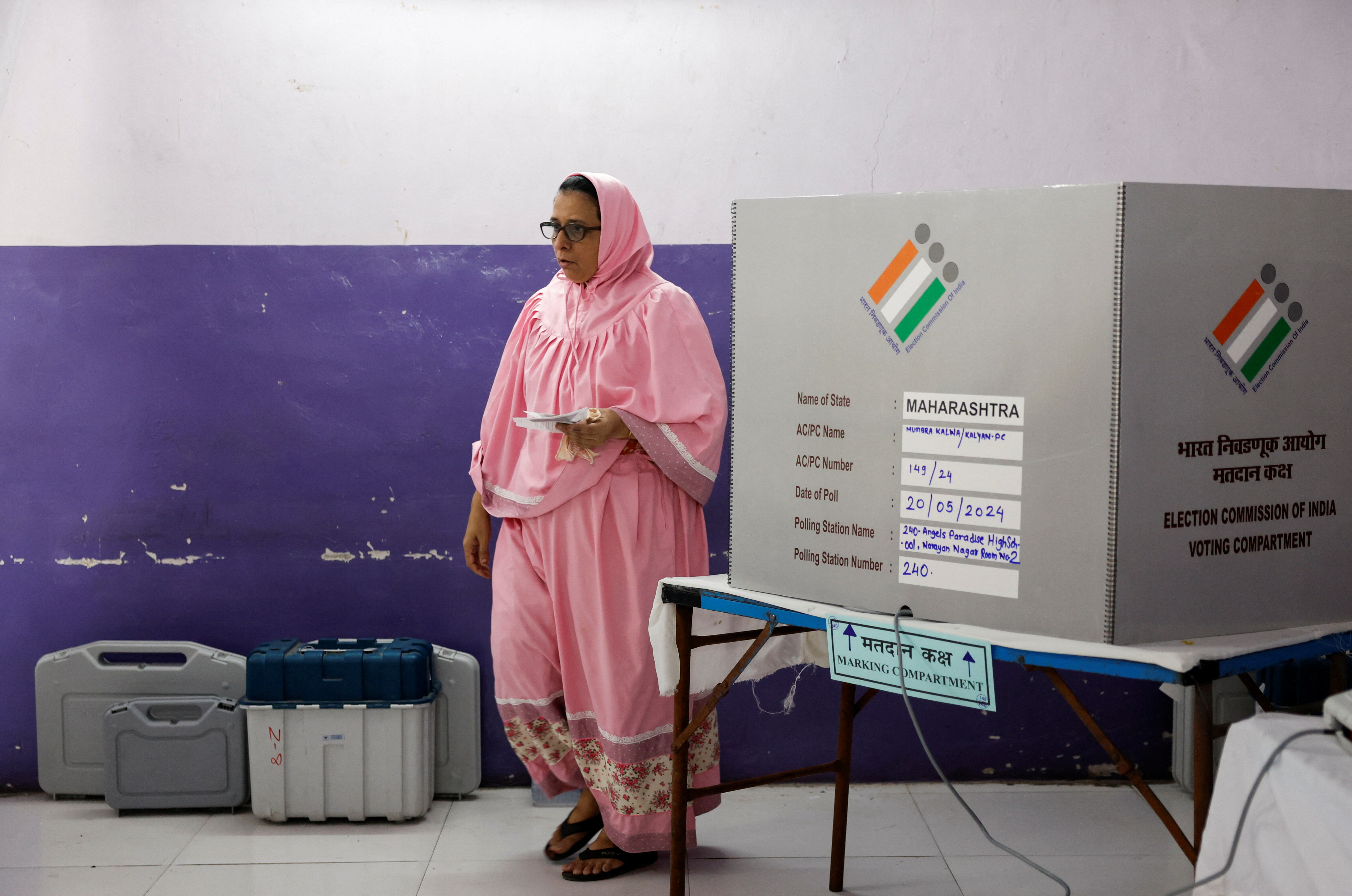 A woman leaves after casting her vote at a polling booth during the fifth phase of India's general election, in Mumbra