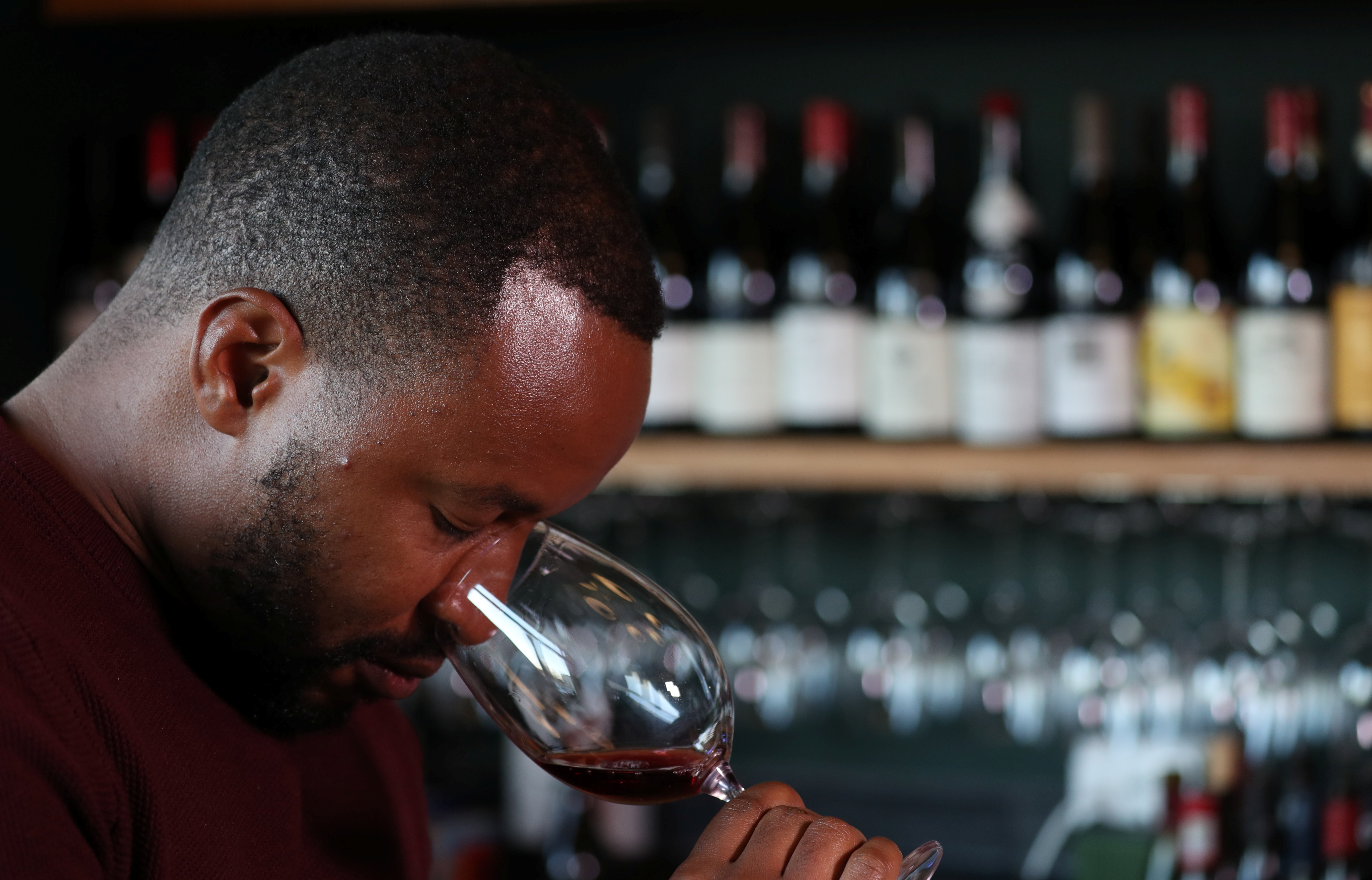 Zimbabwean Tinashe Nyamudoka, a famed sommelier with his own wine brand, smells a glass of wine during an interview with Reuters in Johannesburg, South Africa, June 25, 2021. REUTERS/Siphiwe Sibeko