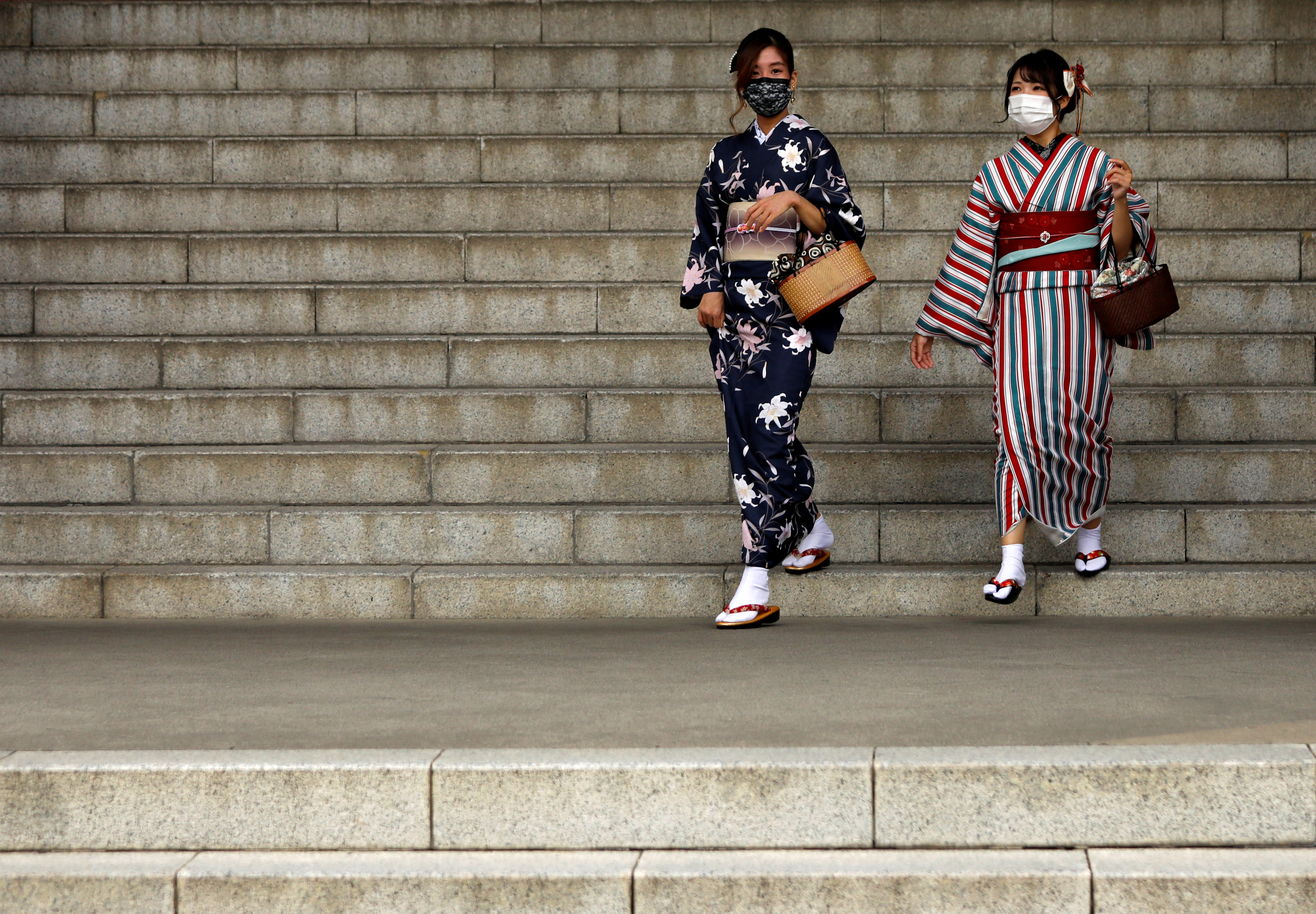 Kimono-clad tourists wearing protective face masks are seen at a temple at Asakusa district, a popular sightseeing spot, amid the coronavirus disease (COVID-19) outbreak in Tokyo